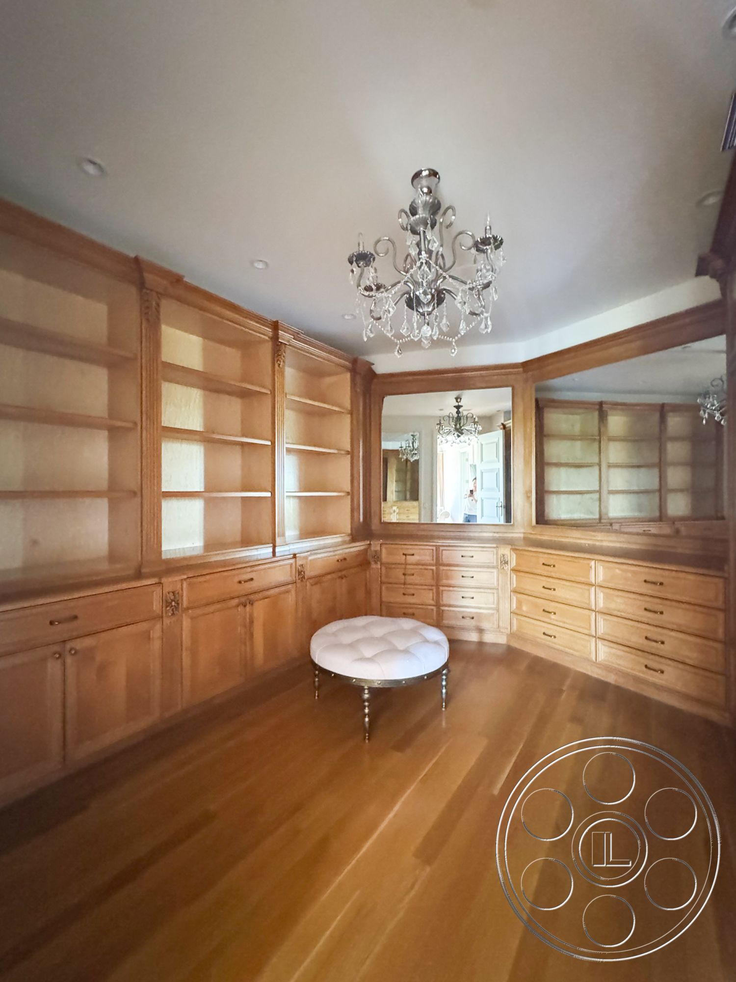 Tiffany Estate - hardwood flooring, chandelier lighting, traditional design elements, tufted ottoman, built-in shelving units, walnut wood cabinetry, mirrored accents