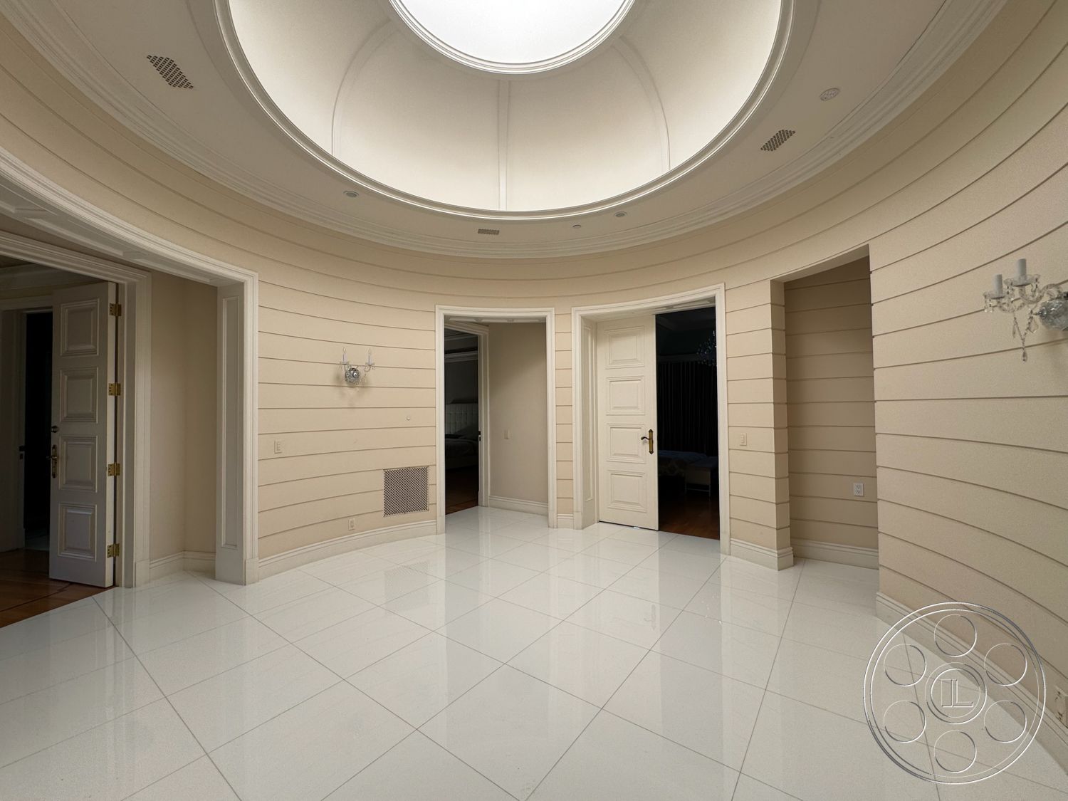 Tiffany Estate - neutral color palette, recessed lighting, arched doorways, textured plaster walls, modern chandelier, glossy tile flooring, white painted walls, crown molding details, curved ceiling design, white paneled doors, circular skylight