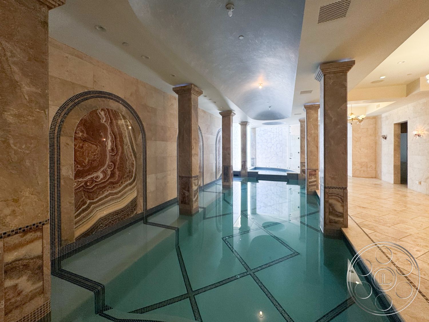 Tiffany Estate - glass shower enclosure, vaulted ceiling, polished stone flooring, textured wall treatments, decorative columns, marble pool deck, arched wall niches, stone feature walls, luxury spa area