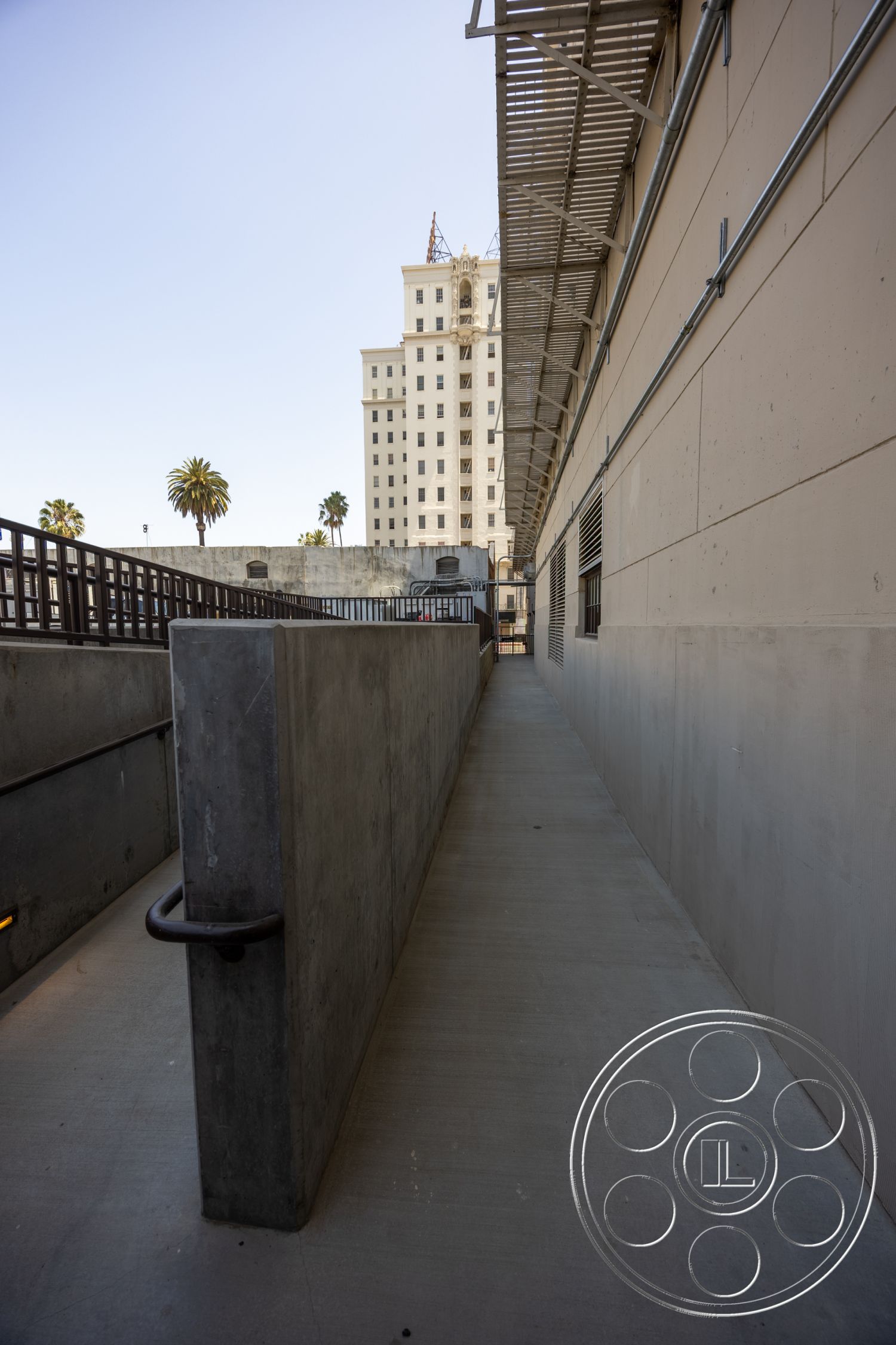 The Plaza - exterior, concrete walls, industrial style, urban setting, steel railing, concrete walkway, linear pathway, adjacent high-rise building