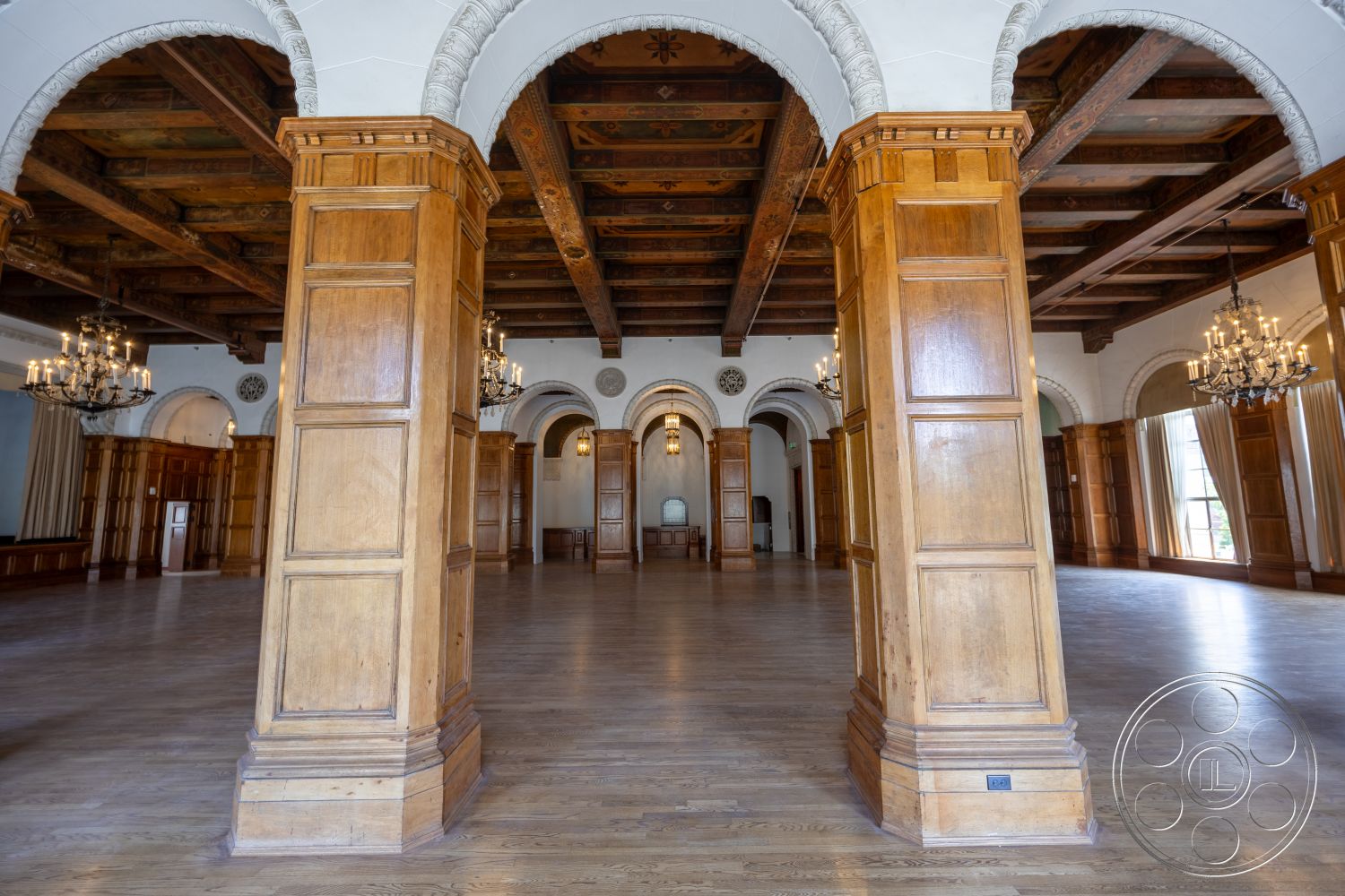 The Plaza - hardwood flooring, exterior, arched doorways, wood beam ceiling, historic architectural style, spacious interior layout, decorative ceiling moldings, chandelier lighting fixtures, elegant event space, exposed wooden columns, panelled wood walls, large windows with drapes, traditional craftsmanship details