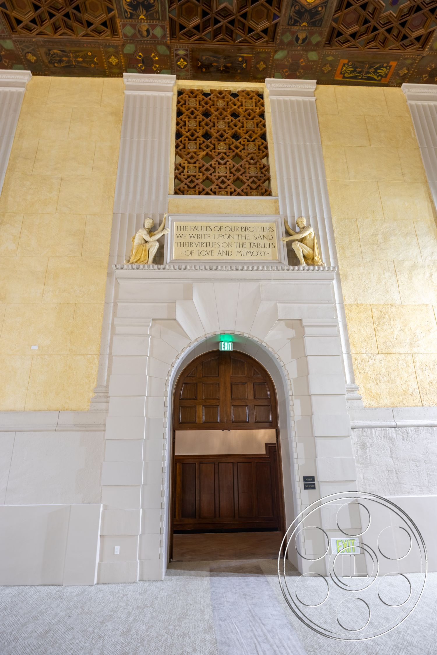 The Plaza - textured plaster walls, arched doorway, exposed wood trim, ornate ceiling design, classical architectural style, wood paneling door, decorative stone detailing, gold leaf ceiling accents, statement wall art, neutral tone carpeting