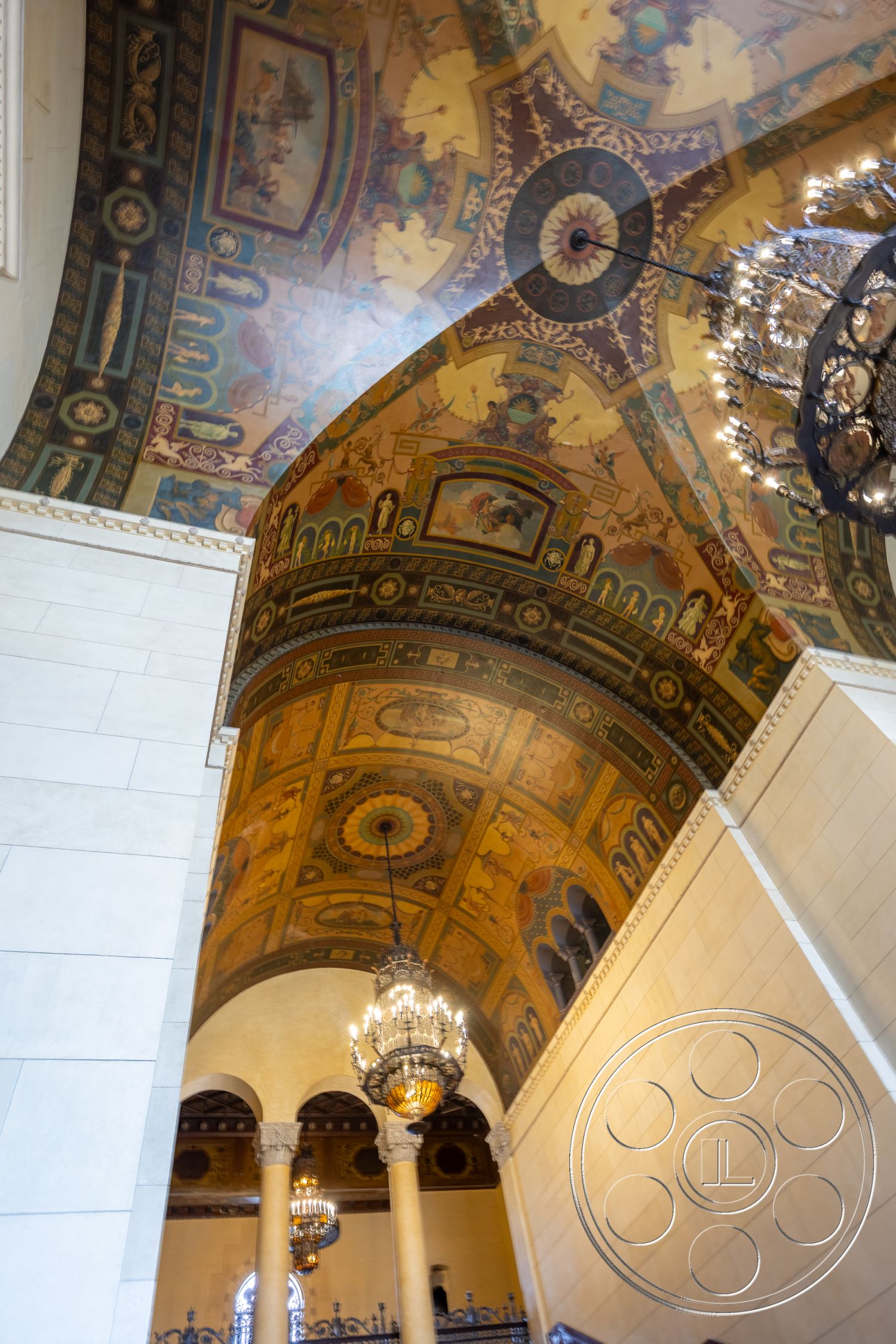 The Plaza - elegant entryway, high vaulted ceilings, plaster wall treatment, historical architectural style, chandelier lighting fixtures, intricate architectural detailing, ornate painted ceiling, curved ceiling forms, marble column supports, gold leaf embellishments