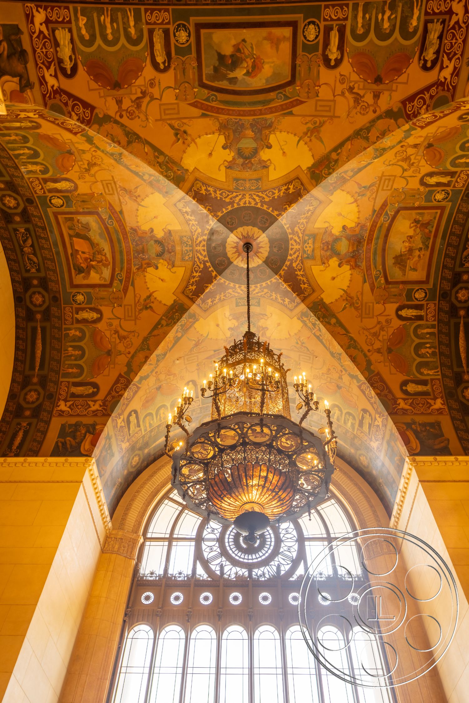 The Plaza - ornate ceiling details, arched windows with decorative trim, historical architectural style, frescoed ceiling panels, chandelier with intricate design, gold and blue color palette, exposed ornate wood structure
