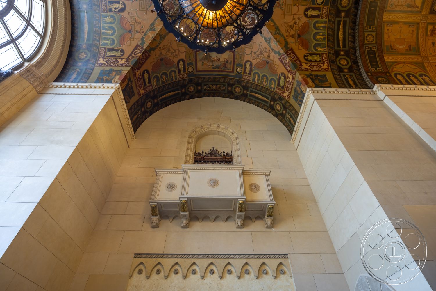 The Plaza - vaulted ceiling, architectural moldings, historical architectural style, grand entrance foyer, ornate wall paneling, decorative coffered ceiling, chandelier with intricate details, ornate ceiling frescoes, smooth stone wall cladding, exposed wall niche, light-colored limestone walls