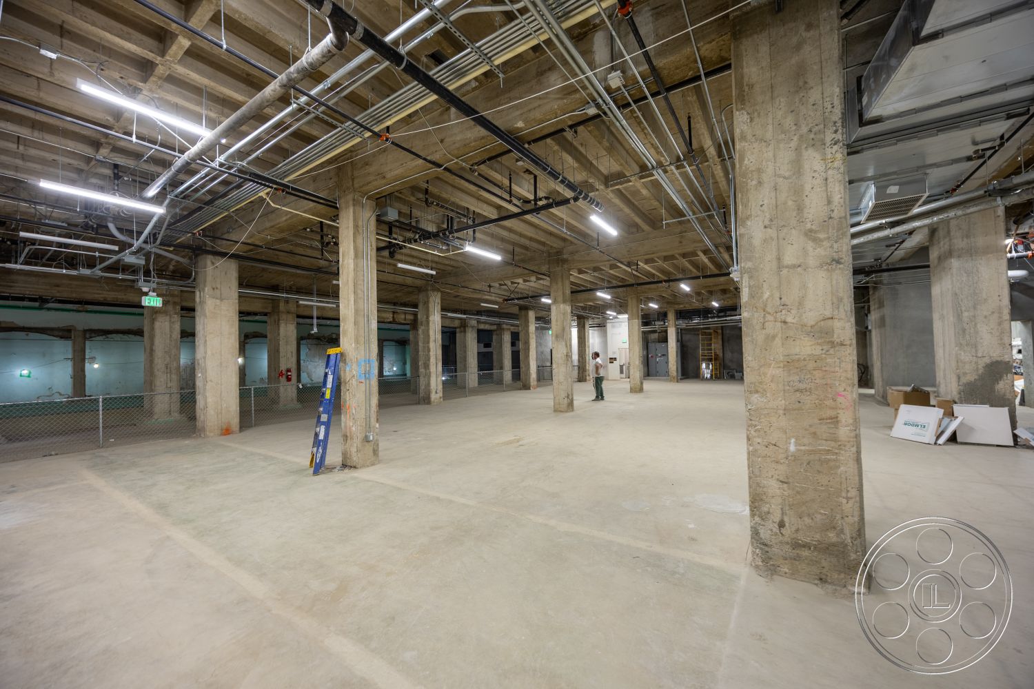 The Plaza - polished concrete floor, open floor plan, exposed concrete walls, industrial lighting fixtures, exposed concrete columns, metal ceiling beams