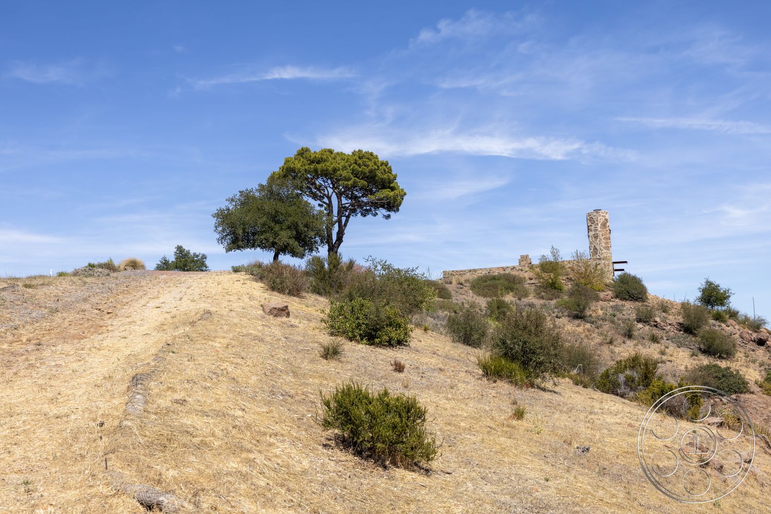 Eagle Feather - exterior, natural vegetation, clear blue sky, rocky hillside, dry grassland, open landscape, stone ruins, distant tree