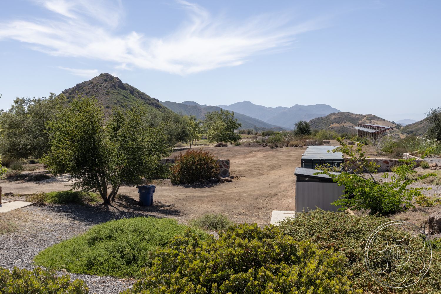 Eagle Feather - exterior, surrounding greenery, natural vegetation, open outdoor space, rocky terrain, scenic backdrop, undulating hills, mountain landscape, distant mountain view, gravel ground covering