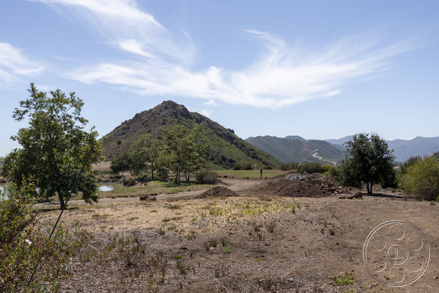 Eagle Feather - exterior, bushes and shrubs, clear blue sky, scenic views, tree line, rocky terrain, dirt pathway, bare earth, mountain landscape, scattered boulders, open field setting, wild grass patches