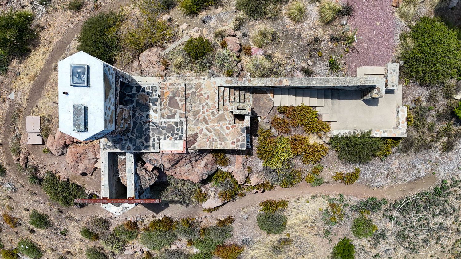 Eagle Feather - exterior, concrete steps, natural stone walls, flagstone path, stone patio flooring, scenic hillside location, rectangular building shape, exposed aggregate concrete surface, landscaped desert setting