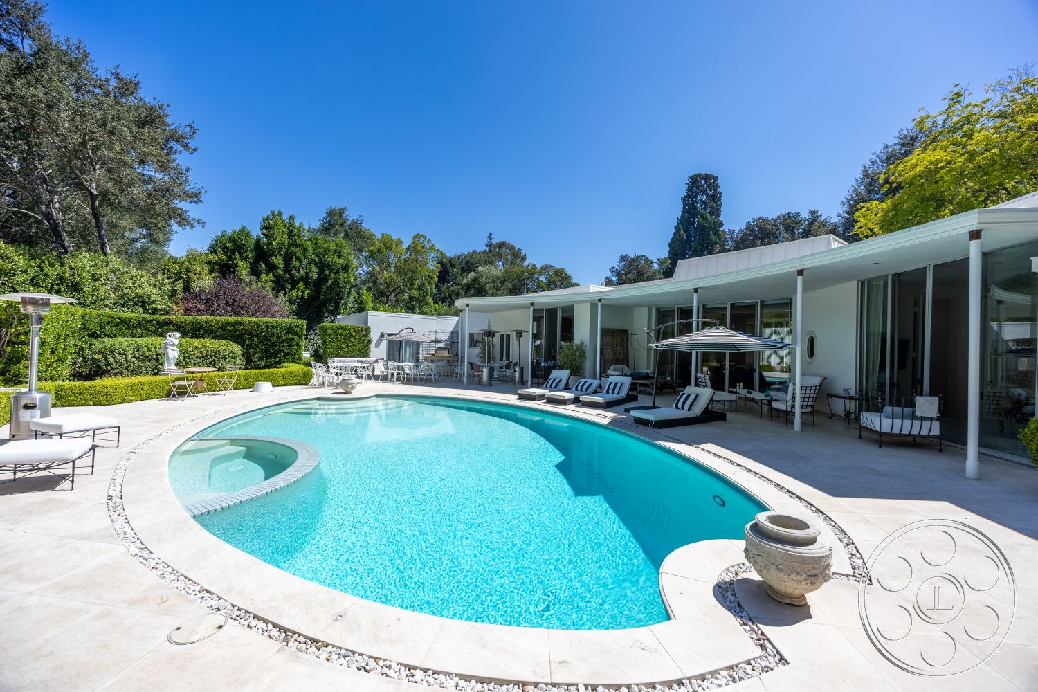 Retro 295 - exterior, glass sliding doors, surrounding greenery, outdoor dining area, modern architectural style, sun loungers, infinity pool, metal patio furniture, concrete pool border, natural stone patio flooring, rectangular patio, green hedge landscaping