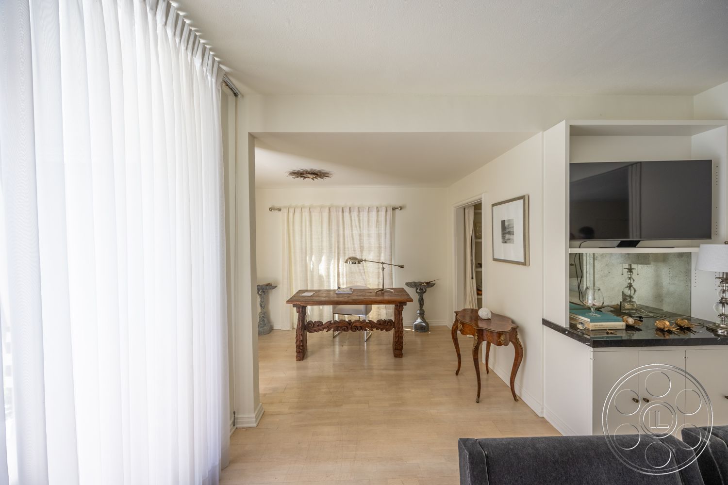 Retro 295 - hardwood flooring, natural wood dining table, open floor plan layout, contemporary wall-mounted television, charming accent side table, sheer white curtain panels, modern cabinetry with granite countertop, artwork framed on white walls, decorative LED ceiling fixture