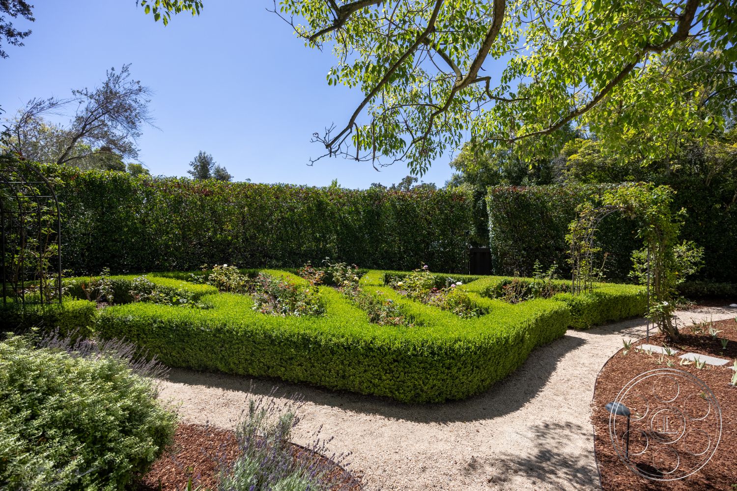 Retro 295 - exterior, low-maintenance landscaping, landscape lighting, boxwood hedges, greenery backdrop, flower bed, perennial flowers, sunlit garden area, mulched flower beds, gravel garden pathway, manicured hedge garden, decorative garden arches, organized garden layout, naturalistic garden design