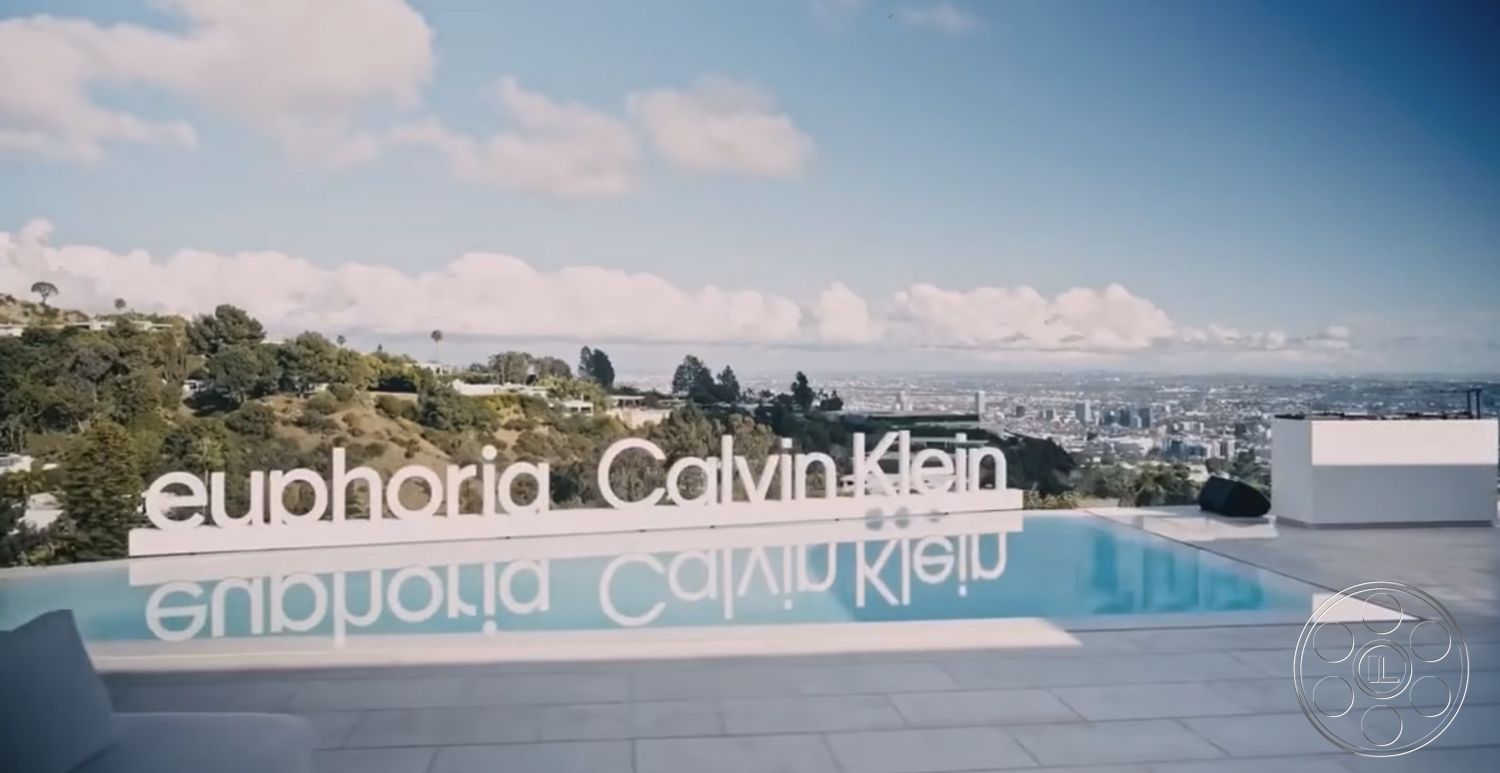 Modern 6 - exterior, clean lines, minimalist design, glass railing, modern outdoor furniture, landscape view, city skyline view, rectangular infinity pool, concrete pool decking, seamless glass doors, panoramic mountain backdrop, white sculptural signage