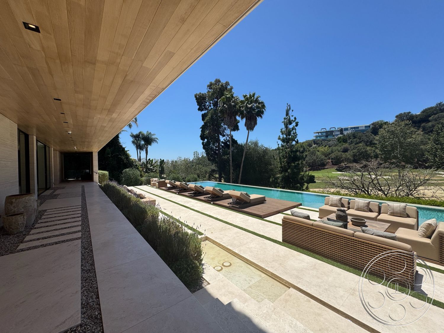 Chalon Estate - exterior, modern architecture, glass windows, wood ceiling panels, wood deck, luxury residential, rectangular pool, poolside lounge area, designed garden, paver walkway, landscaped garden setting, stone patio flooring, concrete pool border, sectional outdoor sofa