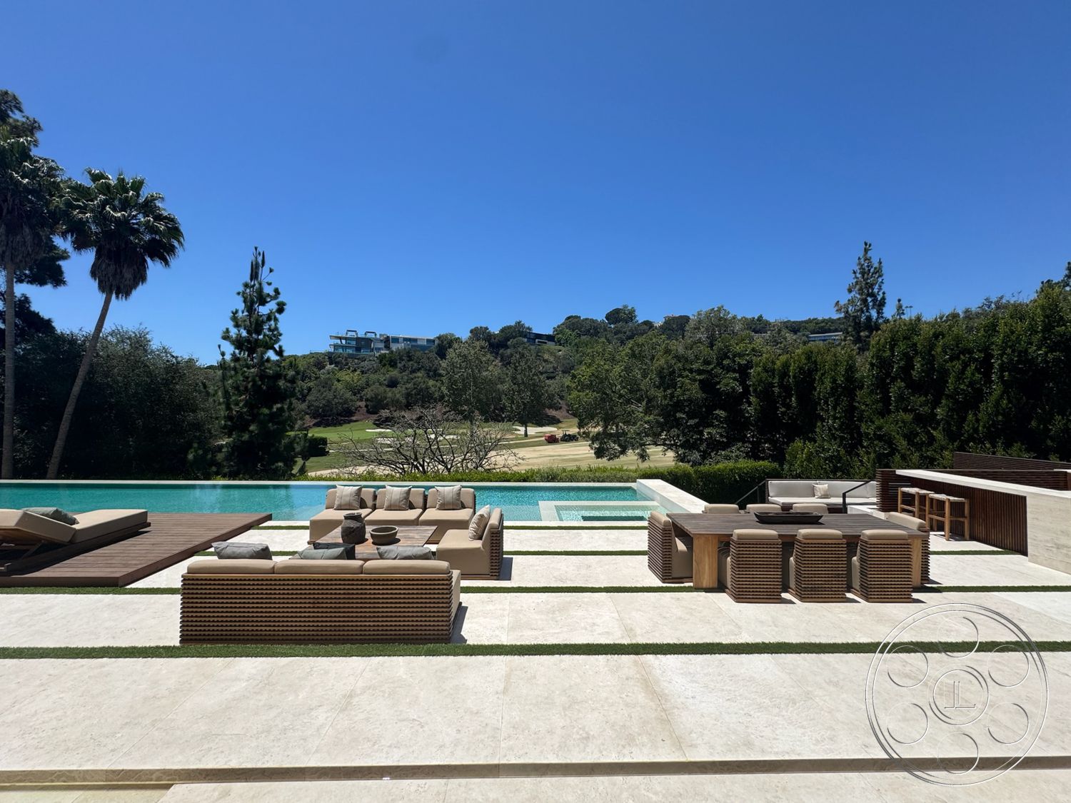 Chalon Estate - exterior, landscaped garden, outdoor seating area, rectangular swimming pool, surrounding trees, rectangular dining table, green grass lawn, wicker outdoor furniture, sunny outdoor setting, concrete patio flooring, wood deck surface, pool border, shallow water area, urban outdoor view