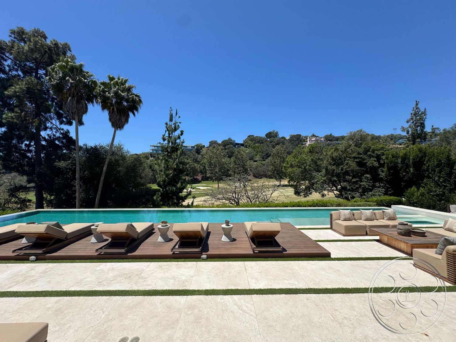 Chalon Estate - exterior, landscaped garden, surrounding greenery, contemporary architecture, infinity pool, modern outdoor lounge area, rectangular pool shape, mountain view setting, stone patio flooring, wooden sun loungers, palms and trees, travertine pool deck, green grass border