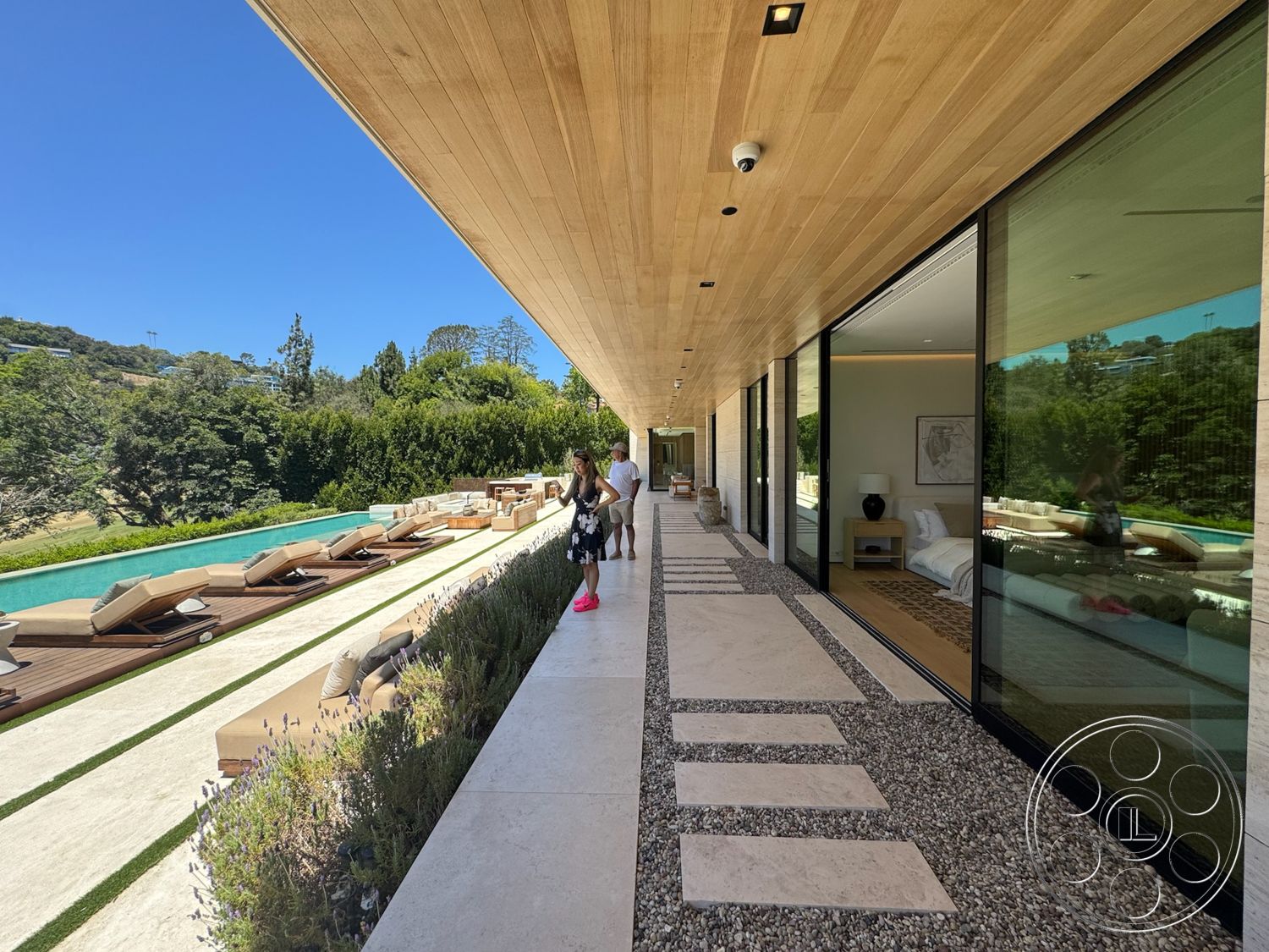 Chalon Estate - exterior, landscaped garden, glass sliding doors, rectangular swimming pool, concrete pathway, wood ceiling panels, modern architectural style, lounge chairs, floor-to-ceiling glass windows, stone patio flooring, gravel garden border, pool with wooden deck