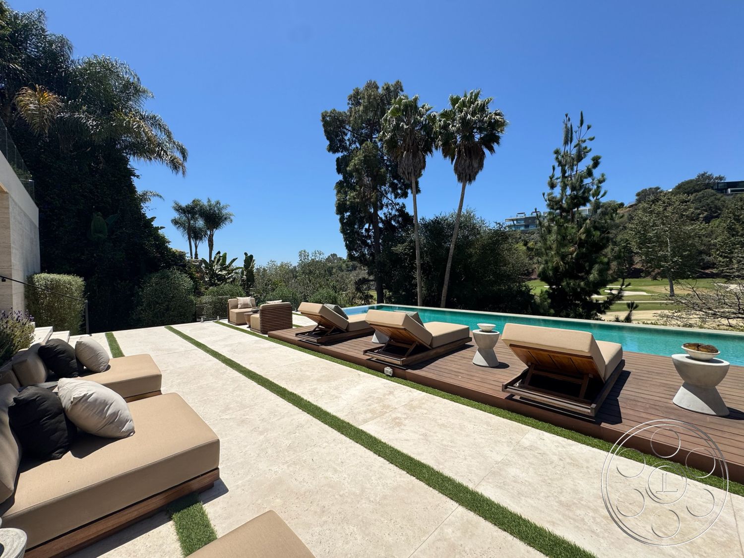 Chalon Estate - exterior, clean lines, palm trees, outdoor seating area, rectangular swimming pool, modern lounge chairs, landscaped garden setting, stone patio flooring, concrete pool border, teak wood deck, soft upholstery cushions