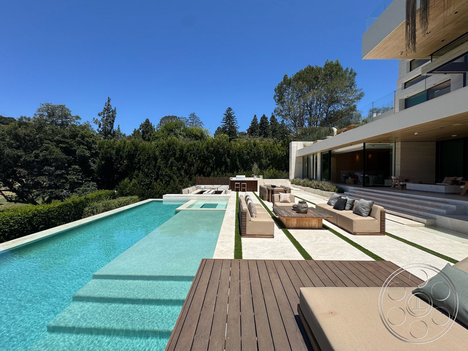 Chalon Estate - exterior, landscaped garden, glass sliding doors, concrete patio, rectangular swimming pool, green lawn, concrete pool deck, stone steps, linear water feature, modern home architecture, open patio area, stainless steel outdoor furniture, luxury outdoor seating area, wood lounge chairs, wood composite deck, exterior feature wall