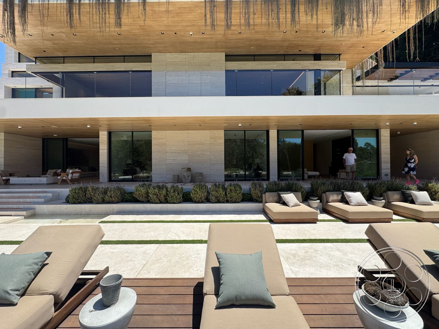 Chalon Estate - exterior, flat roof, stone accent wall, glass sliding doors, rectangular swimming pool, floor-to-ceiling windows, natural stone pathways, outdoor living area, modern lounge chairs, horizontal wooden slats, concrete patio flooring, landscaped garden beds, minimalist architectural style, horizontal lines in design, wood ceiling details