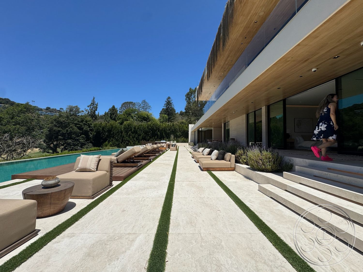 Chalon Estate - exterior, landscaped garden, contemporary design, glass sliding doors, outdoor lounging area, horizontal wood paneling, rectangular pool, minimalist architecture, concrete patio flooring, light-colored stone steps, wood deck lounge area, flat wooden roof, creek-side view