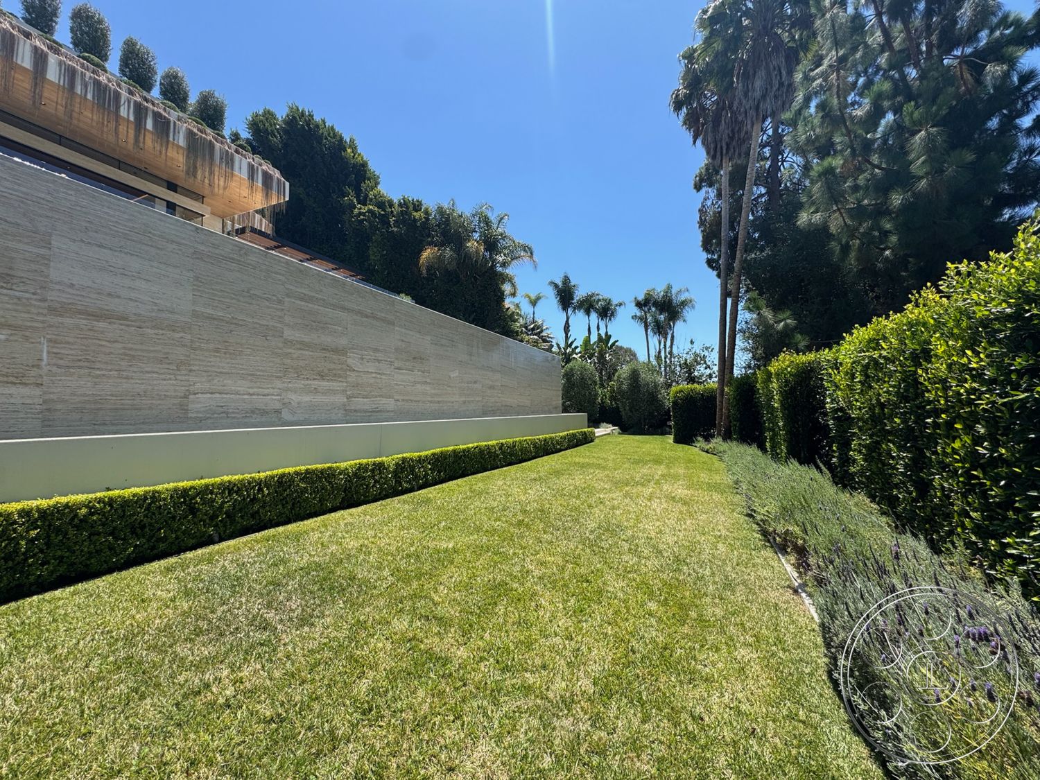 Chalon Estate - exterior, clear blue sky, tropical palm trees, hedge landscaping, landscaped pathway, modern architectural design, manicured grass lawn, suburban garden setting, stone wall elevation, concrete planter border