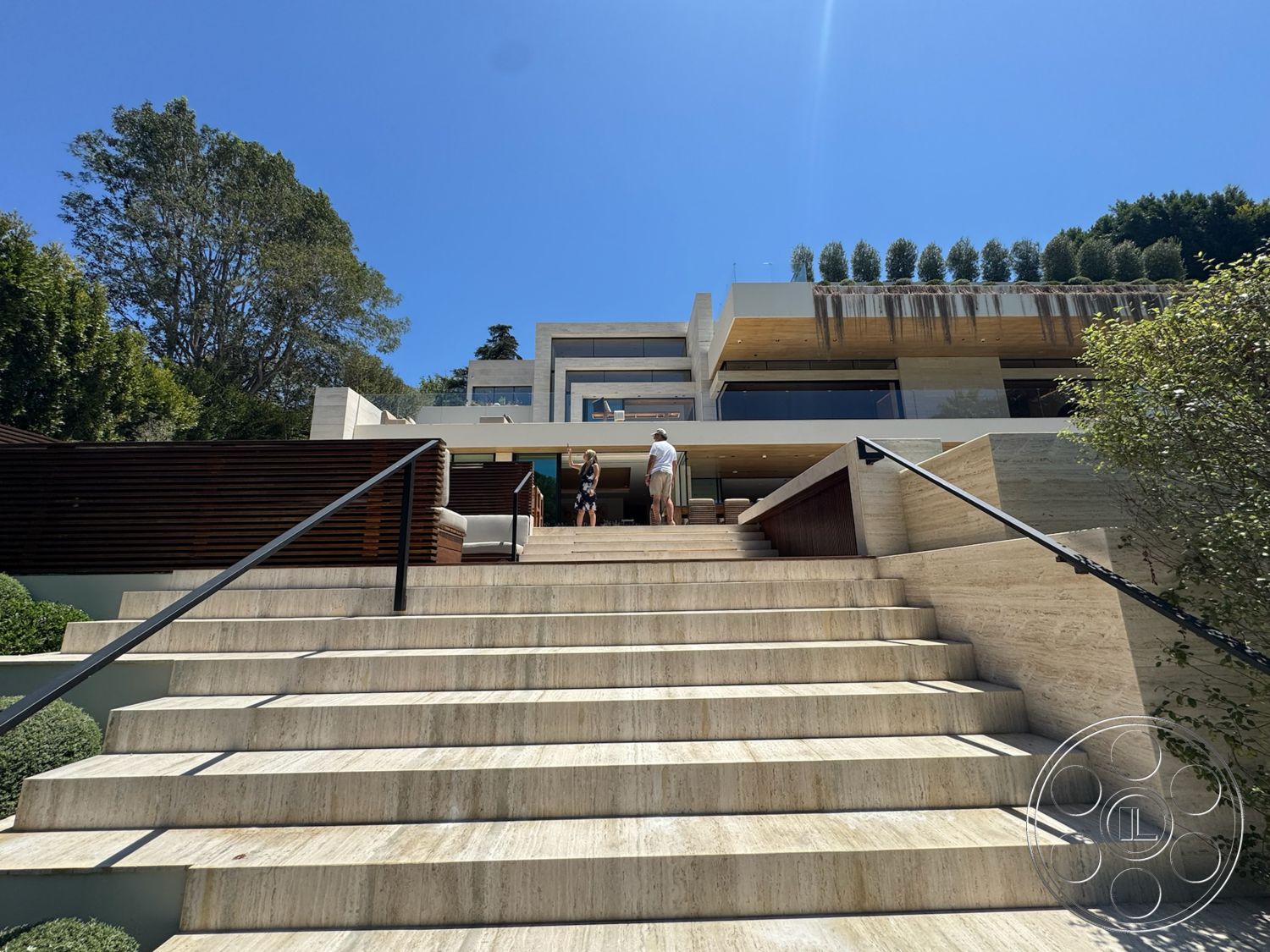 Chalon Estate - exterior, landscaped garden, wooden deck, concrete walls, modern architectural style, glass balcony railing, rectangular steps, travertine steps, ceiling with exposed wood beams, tree backdrop, linear planters