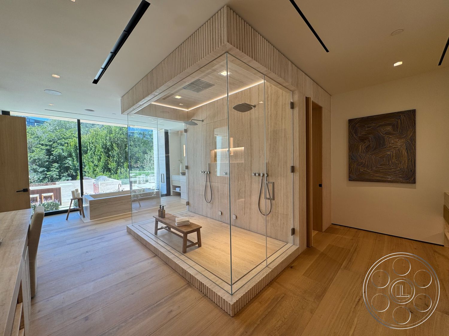 Chalon Estate - stone accent wall, freestanding bathtub, glass shower enclosure, natural light from large windows, light wood paneling, recessed ceiling lights, frosted glass partition, wooden bathroom cabinetry, open bathroom layout, minimalist design accents, textured wood flooring, modern flush mount lighting, geometric art piece, architectural details with vertical lines
