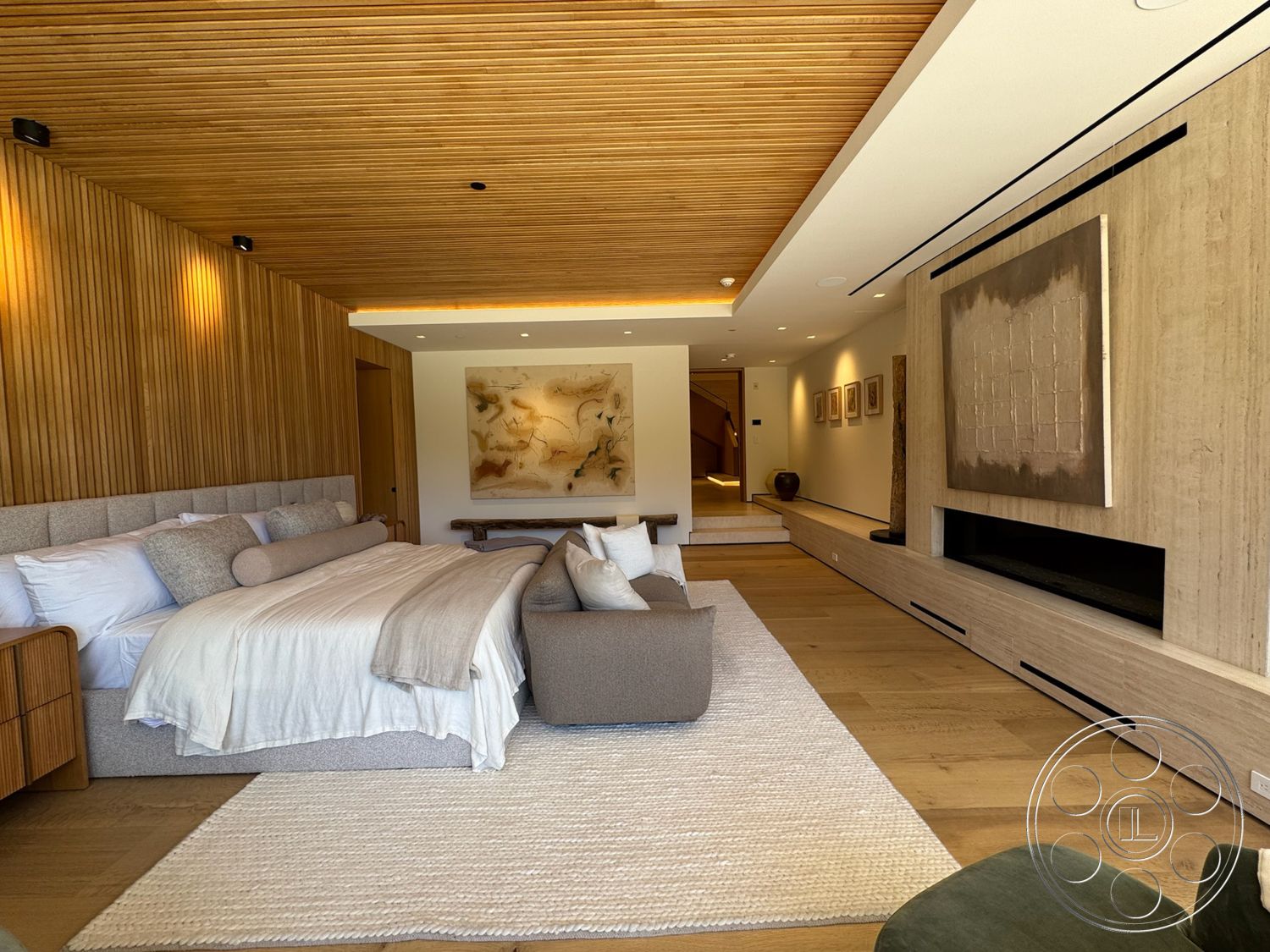 Chalon Estate - neutral color palette, natural wood accents, modern art wall decor, exposed wood ceiling beams, recessed lighting fixtures, minimalist furniture design, wood paneling walls, fabric upholstered bed, horizontal wood accent wall, built-in media console, plank wood flooring, light fabric bedding, contemporary rug