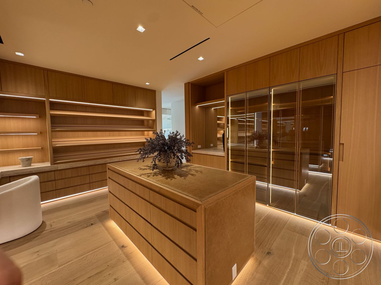 Chalon Estate - neutral color palette, light wood flooring, natural wood cabinetry, open shelving, glass-front cabinet doors, stone countertop, built-in shelves, modern minimalist design, contemporary storage solutions, LED backlighting