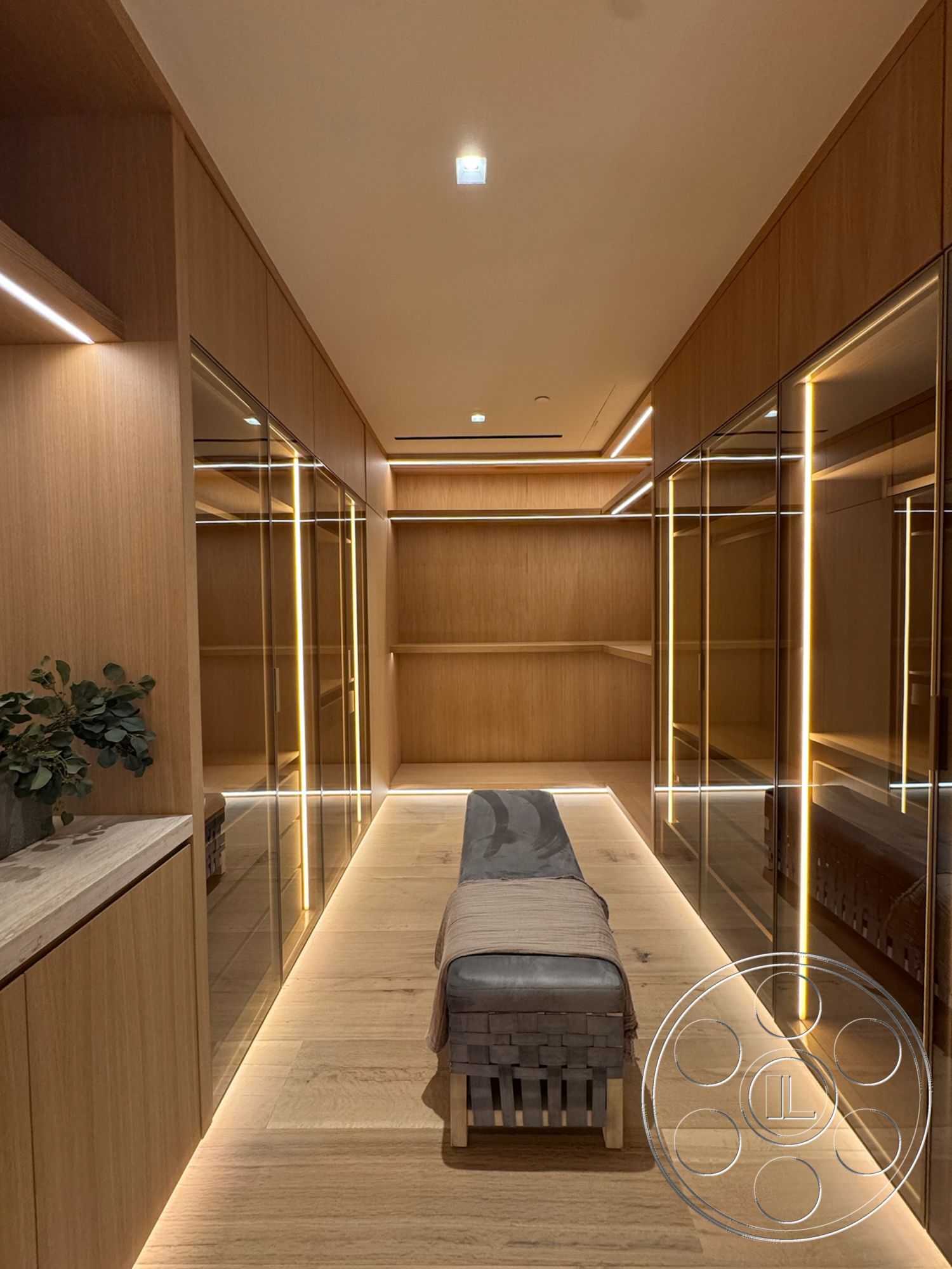 Chalon Estate - light hardwood flooring, minimalistic design, mirrored closet doors, recessed ceiling lighting, flush-mounted ceiling lights, light wood paneling walls, woven bench seating, linear LED accent lighting