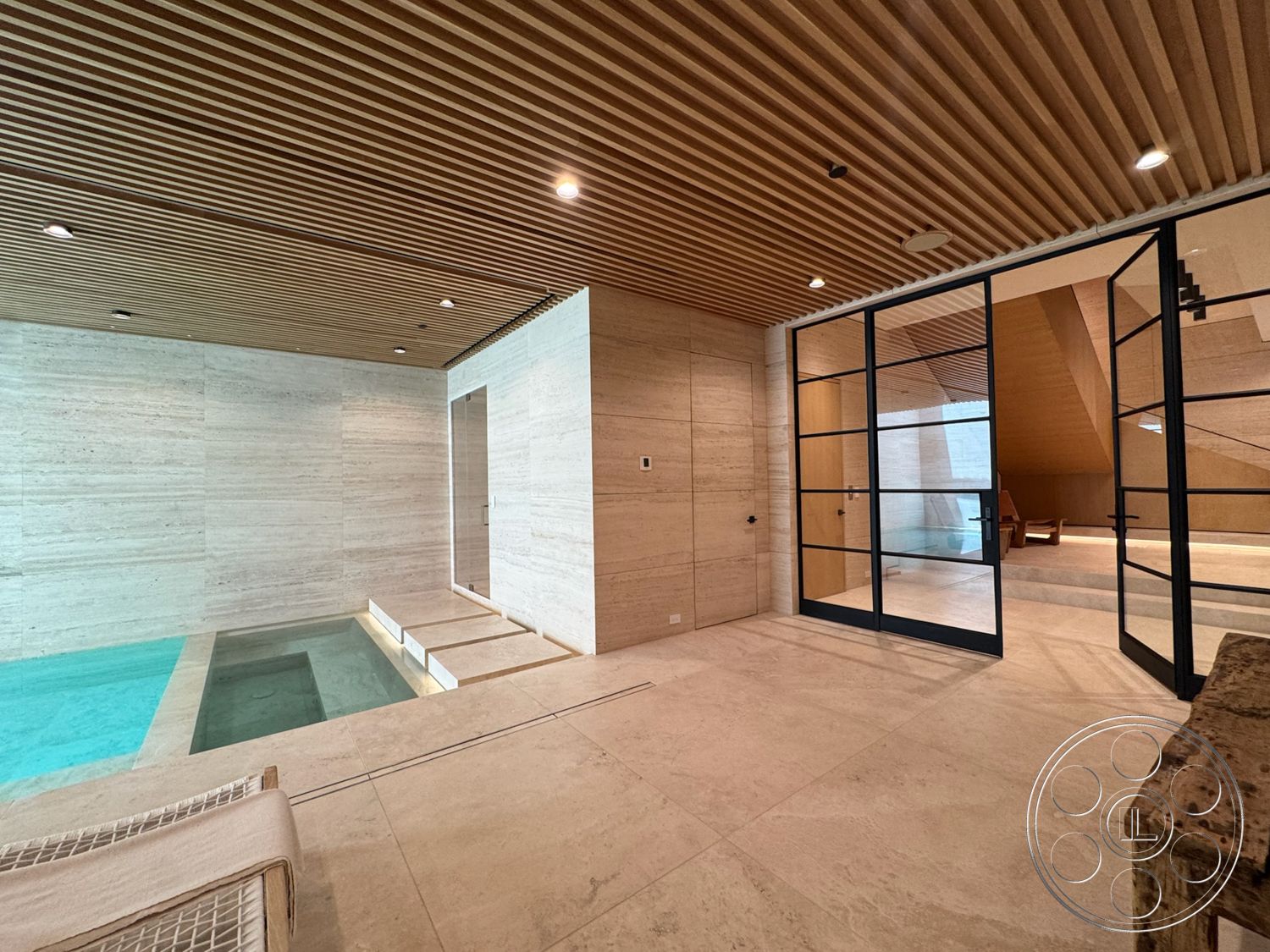 Chalon Estate - open floor plan, glass sliding doors, modern architectural style, marble flooring, horizontal wood slats, built-in seating area, exposed wood ceiling panels, concrete plunge pool, textured stone accent walls
