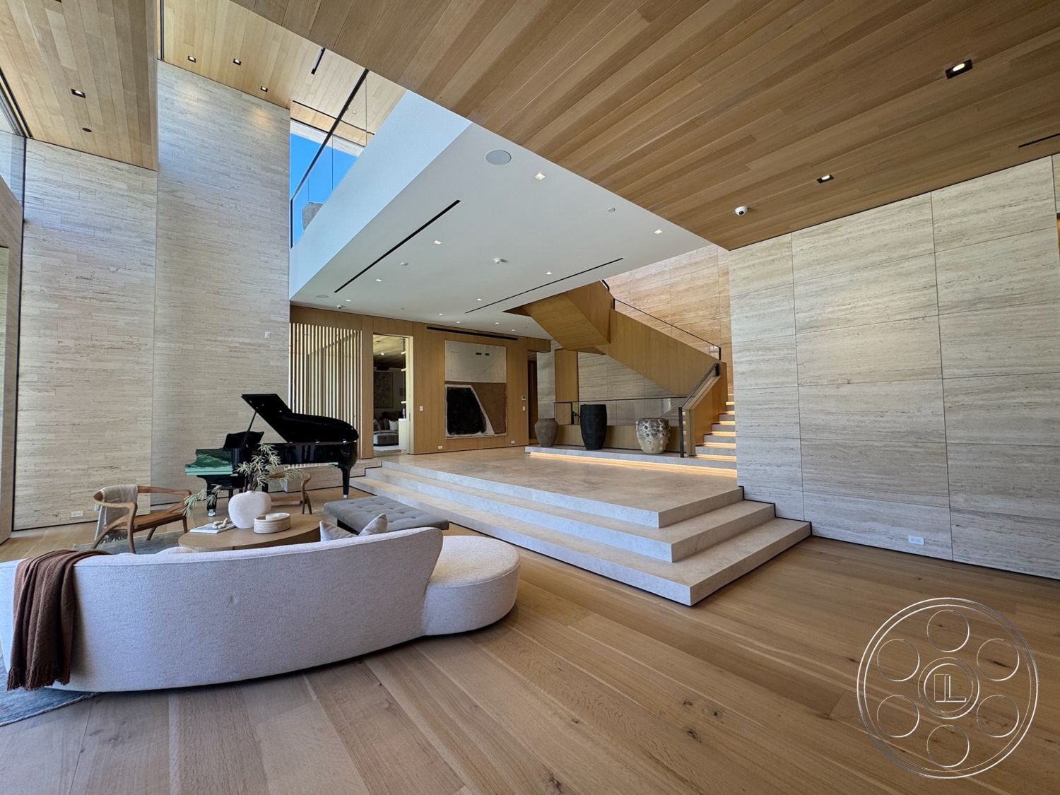 Chalon Estate - high ceilings, neutral color palette, natural light, hardwood flooring, open floor plan, decorative vases, large glass windows, integrated lighting, sitting area, minimalist furniture, concrete steps, textured wall surfaces, wood ceiling panels, floating staircase, modern piano, travertine wall panels