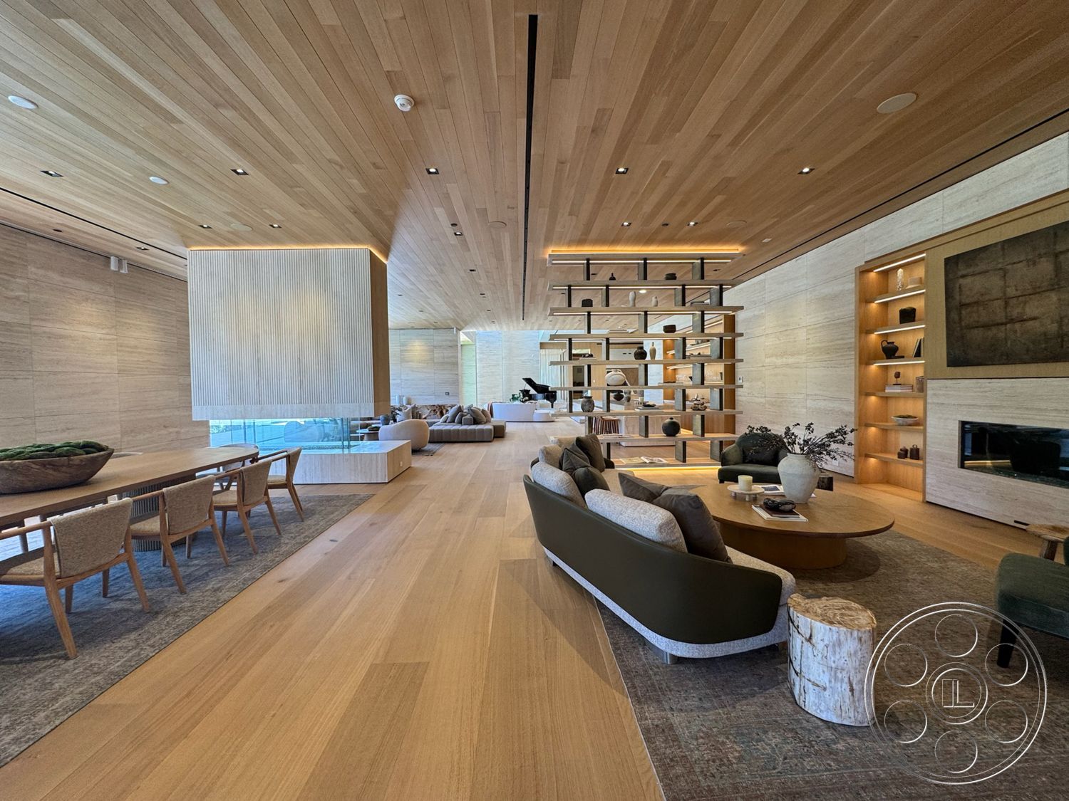 Chalon Estate - neutral color palette, large windows, open floor plan, modern lighting fixtures, cozy seating area, wood panel ceiling, textured plaster walls, contemporary coffee table, exposed structural elements, modern dining area, hardwood living room floors, minimalist furniture design, potted indoor plants, natural stone feature wall, floating bookshelf