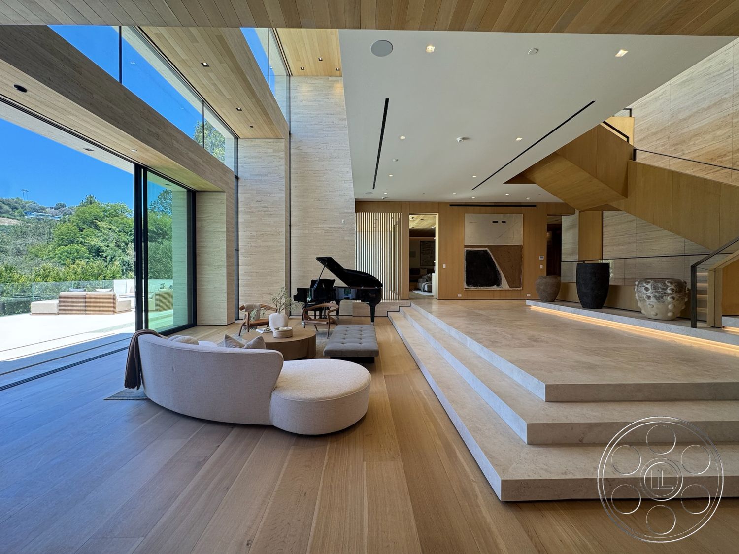 Chalon Estate - minimalist decor, natural light, indoor plants, light hardwood flooring, open floor plan, large floor-to-ceiling windows, contemporary staircase, exposed wood ceiling, concrete accent wall, textured vertical wood paneling, modern piano, stone step risers, neutral upholstered seating, elegant living area