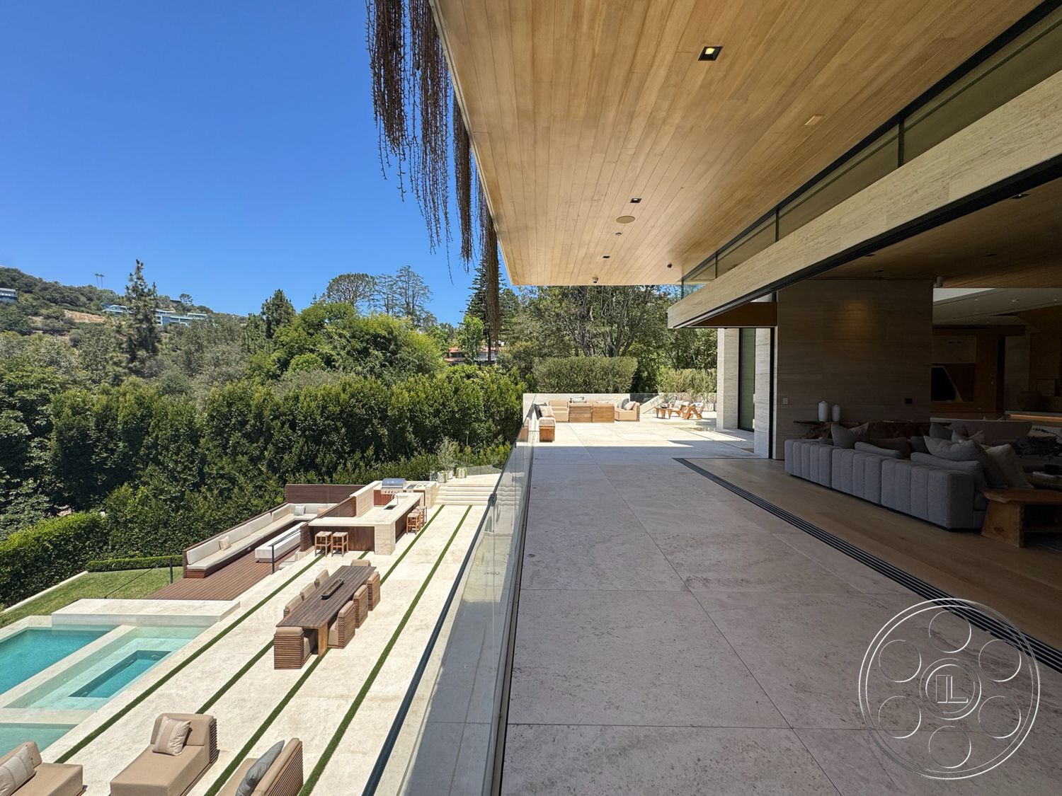 Chalon Estate - exterior, large glass sliding doors, exposed wooden ceiling, floor-to-ceiling windows, horizontal wood fencing, modern architectural style, rectangular pool, wooden outdoor furniture, stone pool deck, landscaped garden area, concrete patio flooring, open outdoor living space, natural stone wall cladding
