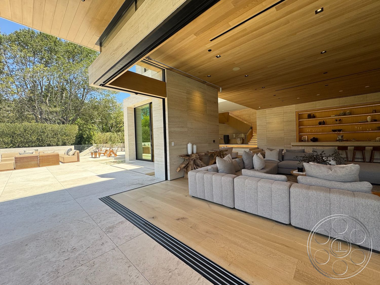 Chalon Estate - natural light, modern furnishings, open concept layout, sliding glass doors, floor-to-ceiling windows, contemporary architecture, wood beam ceiling, built-in wooden shelves, concrete accent wall, tile patio flooring, rectangular patio, oak hardwood living room floors