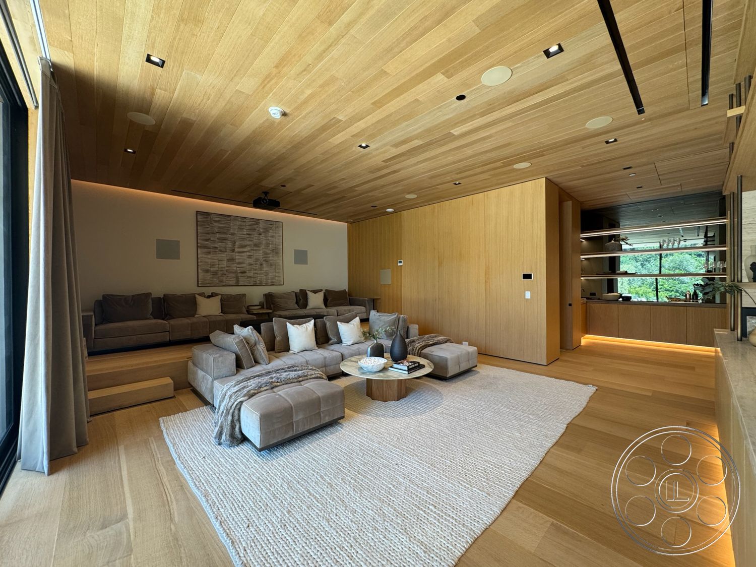 Chalon Estate - hardwood flooring, recessed lighting, textured area rug, modern coffee table, light wood paneling, interior living room, open floor layout, exposed wood ceiling, contemporary wall art, large windows with outdoor view, plush upholstered sectional sofa, neutral colored throw pillows, minimalist shelving unit, subtle accent lighting