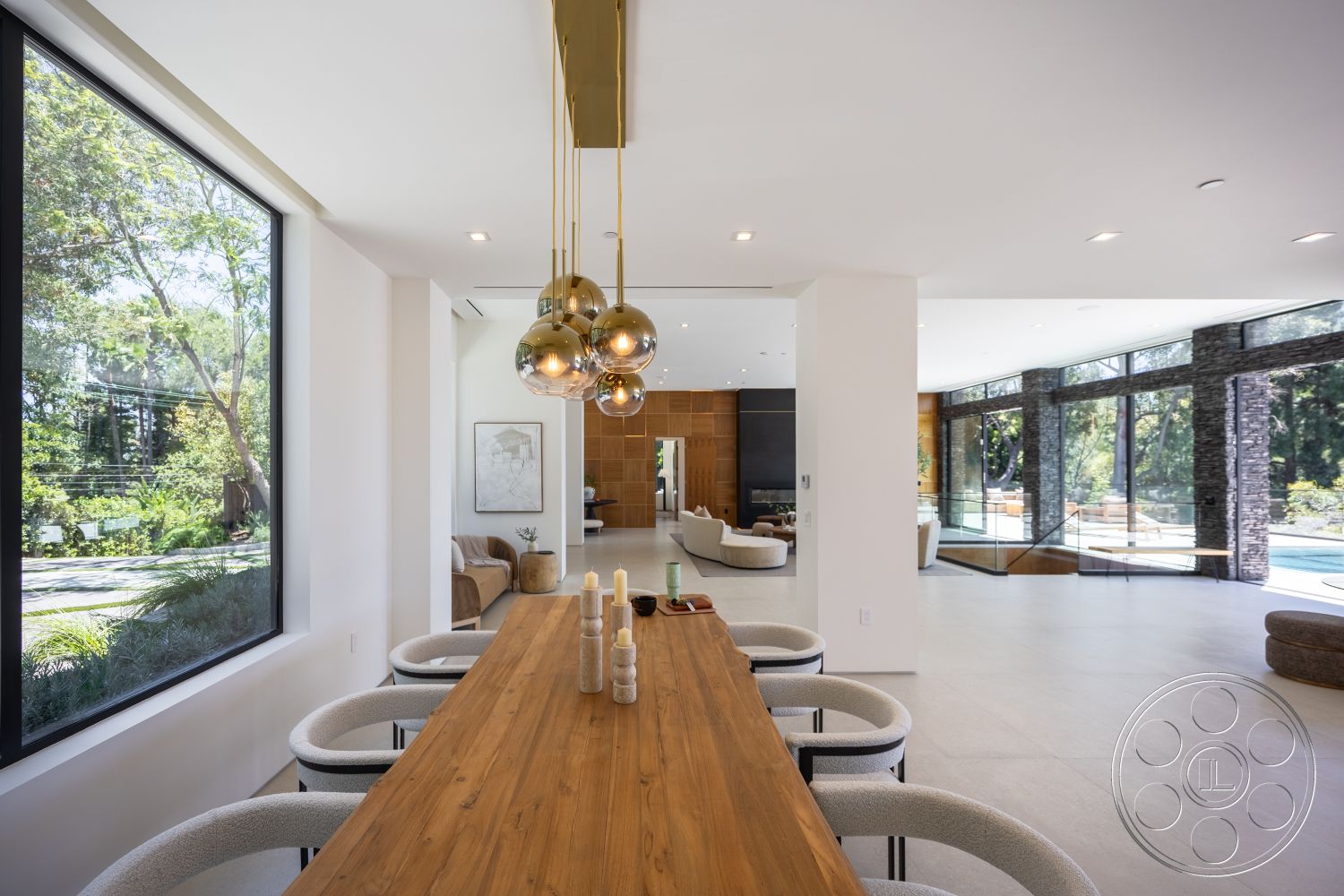 Canyon House - white walls, natural light, minimalist design, indoor plants, open floor plan, stainless steel appliances, large glass windows, wood dining table, wood accent wall, contemporary dining chairs, neutral tile flooring, indoor-outdoor living space, suspended pendant lights, modern living room area
