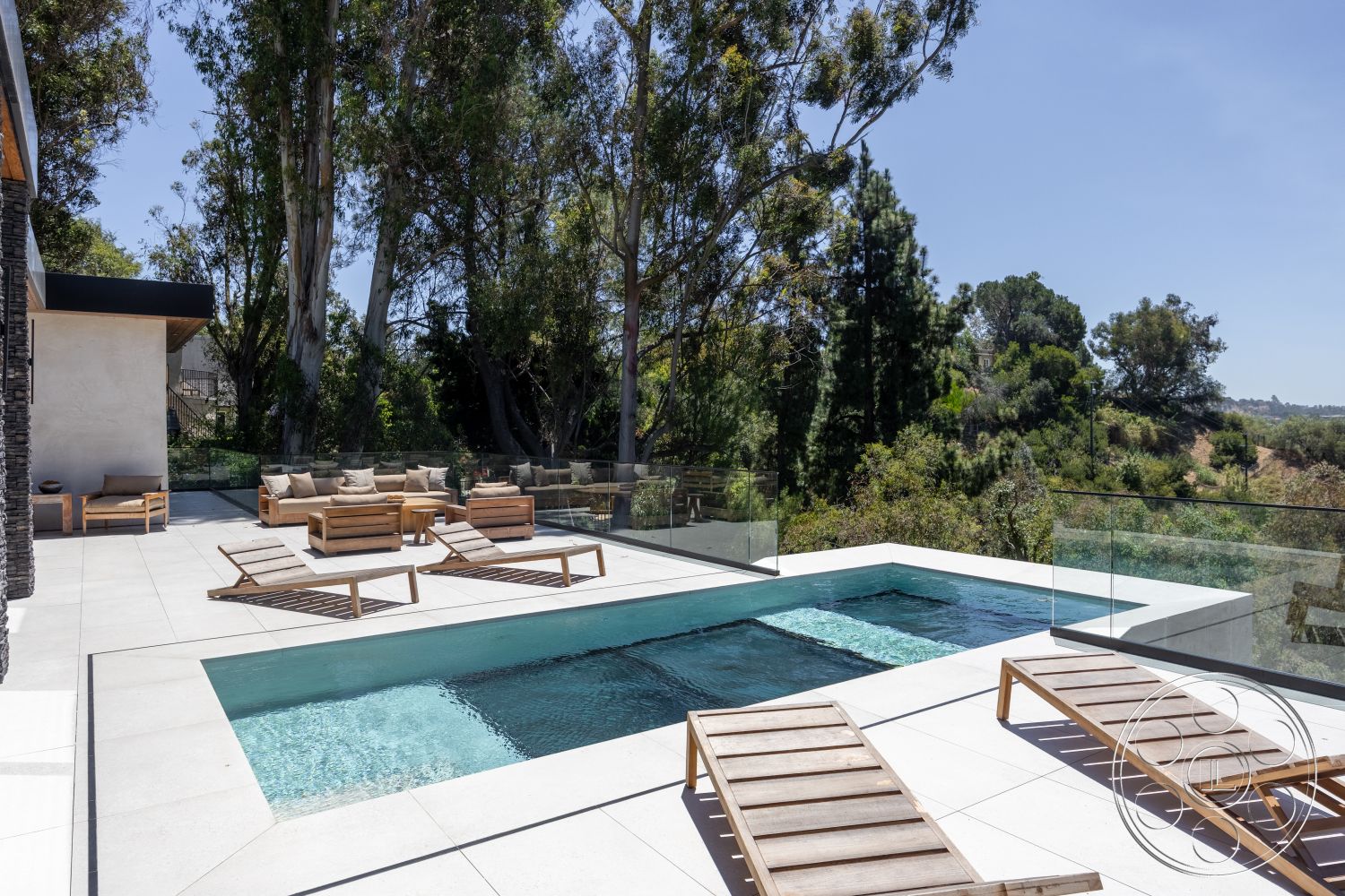 Canyon House - exterior, modern architecture, outdoor seating area, glass railing, surrounding trees, concrete pool deck, rectangular pool, wooden lounge chairs, concrete patio flooring, multi-level landscape