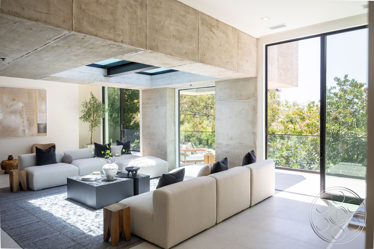 Canyon House - minimalist decor, neutral color palette, natural light, contemporary design, textured area rug, open floor plan, concrete walls, floor-to-ceiling windows, black coffee table, indoor greenery, exposed concrete ceiling, plank flooring, glass wall, light-colored sectional sofa