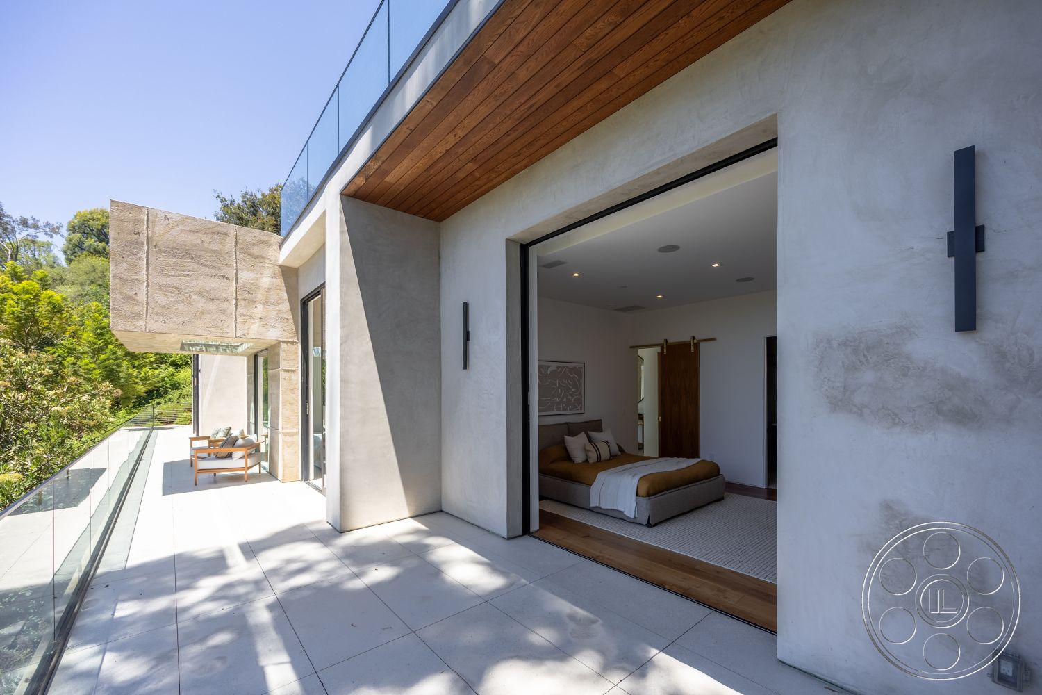 Canyon House - exterior, sliding glass doors, modern architectural style, concrete patio flooring, landscaped garden setting, wood beam ceiling, smooth stucco wall finish, glass balcony railing, plank wood ceiling