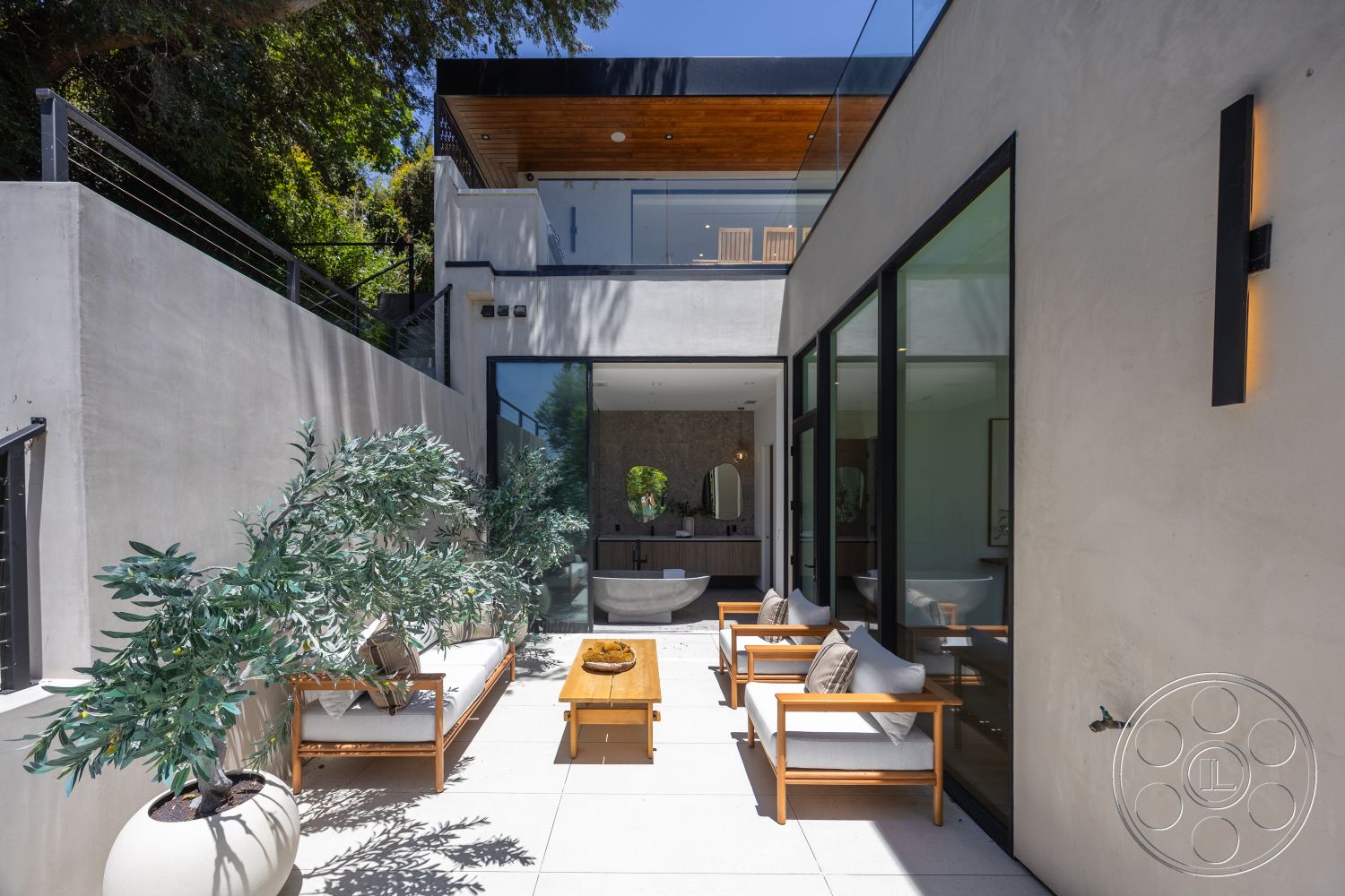 Canyon House - exterior, modern outdoor furniture, floor-to-ceiling windows, stucco walls, contemporary architectural style, concrete patio flooring, wood beam ceiling, glass door entrance, lush greenery landscaping, minimalist wall sconces, open courtyard layout, granite table surface, rectangular modern seating area