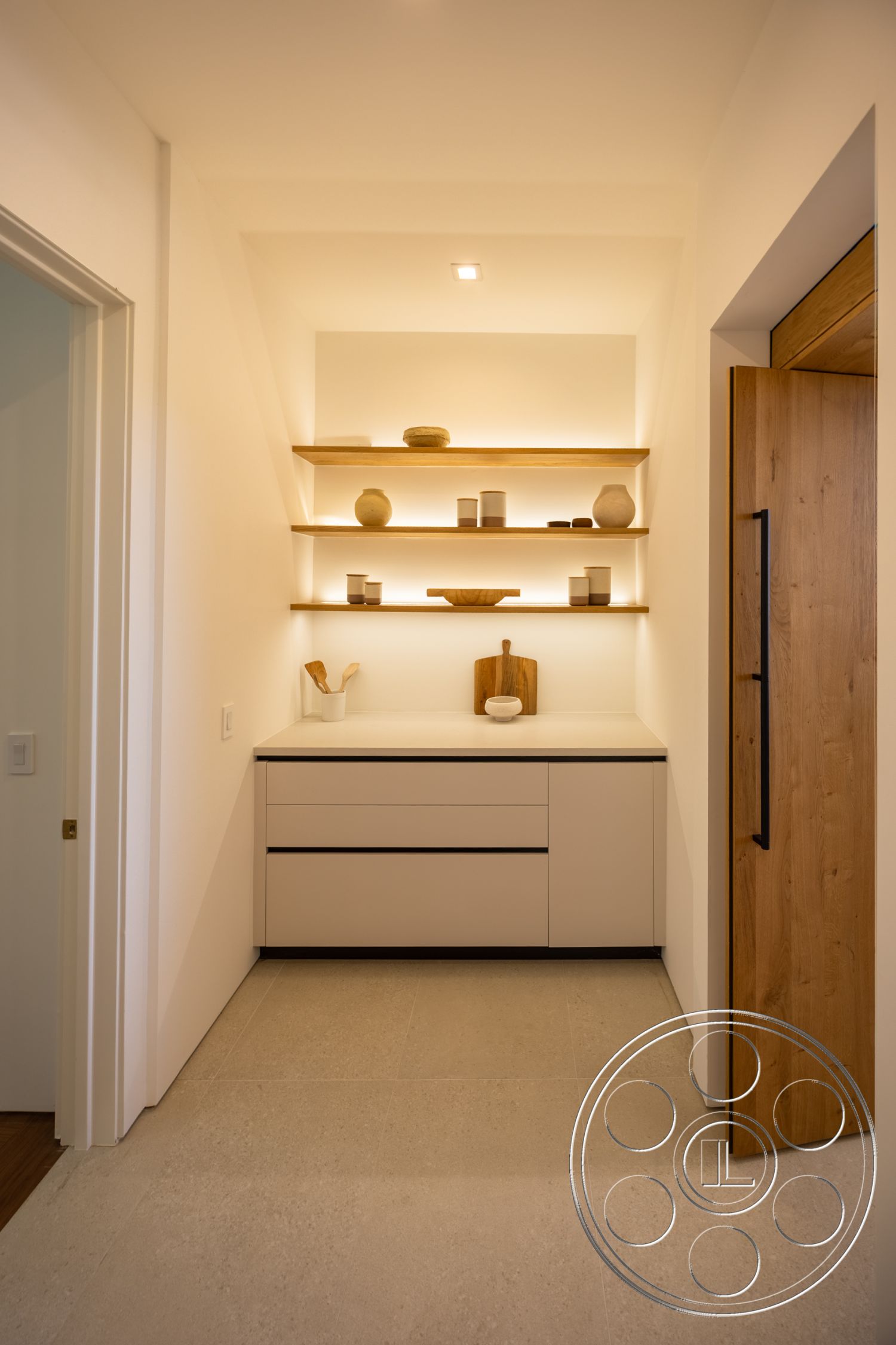 Canyon House - minimalist design, modern cabinetry, textured wall treatment, natural wood door, white painted walls, concrete tile flooring, light wood finish shelves, open shelving with decorative objects