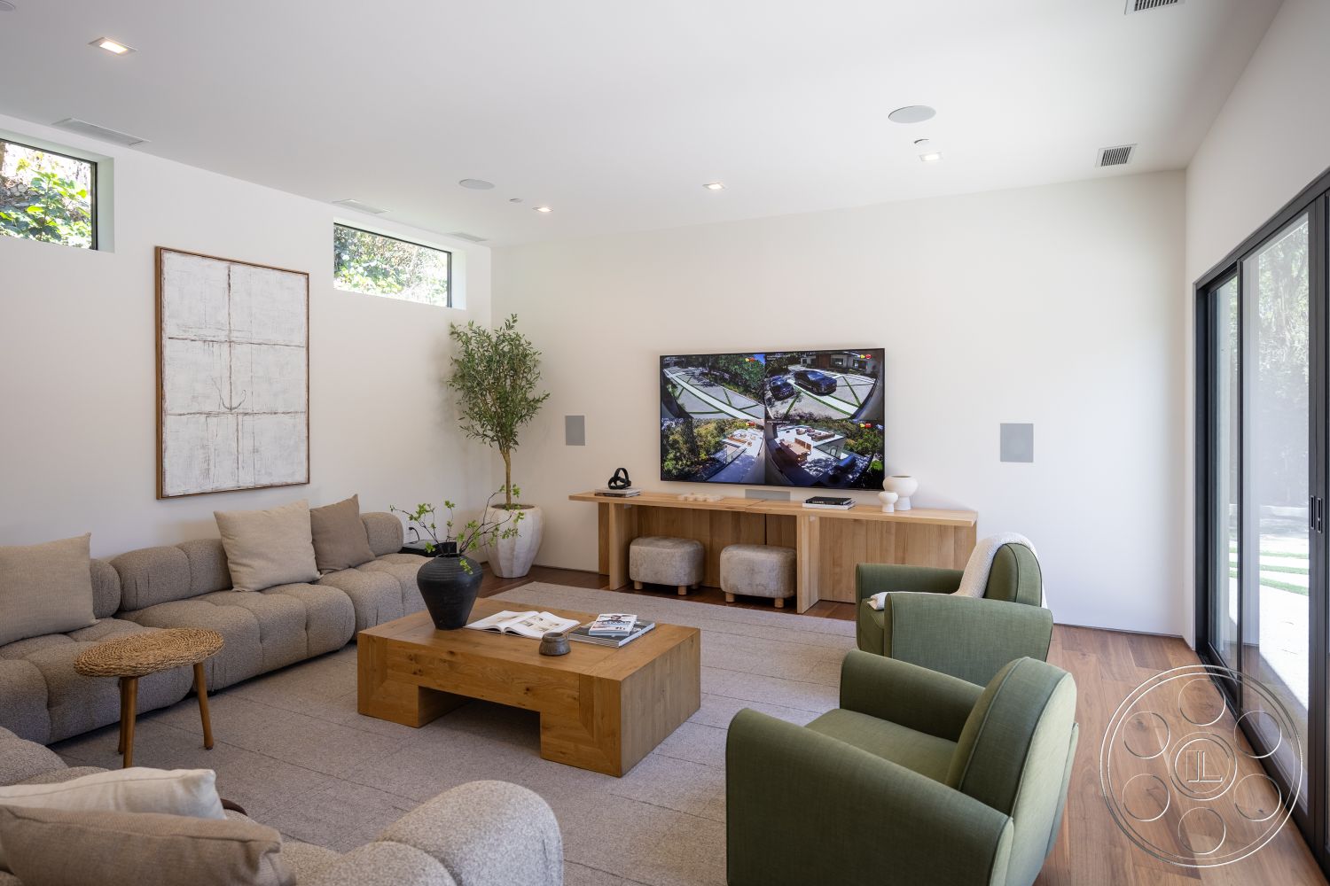 Canyon House - contemporary design, wood coffee table, minimalist aesthetic, light hardwood flooring, framed wall art, indoor greenery, natural light from windows, floor-to-ceiling glass sliding doors, textured white plaster walls, sectional fabric sofa, modern side chairs, low-profile media console
