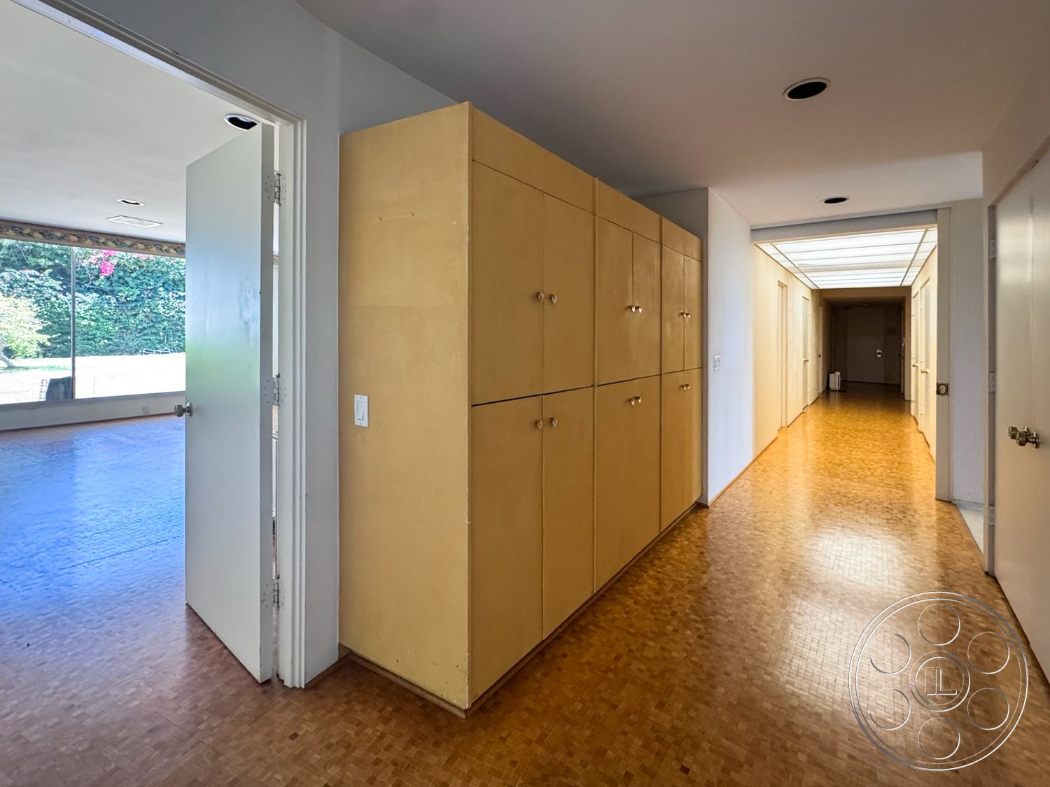 MCM 28 - natural light, indoor-outdoor flow, open concept design, floor-to-ceiling windows, bamboo flooring, modern minimalist design, white painted walls, rectangular hallway, wood paneling cabinetry