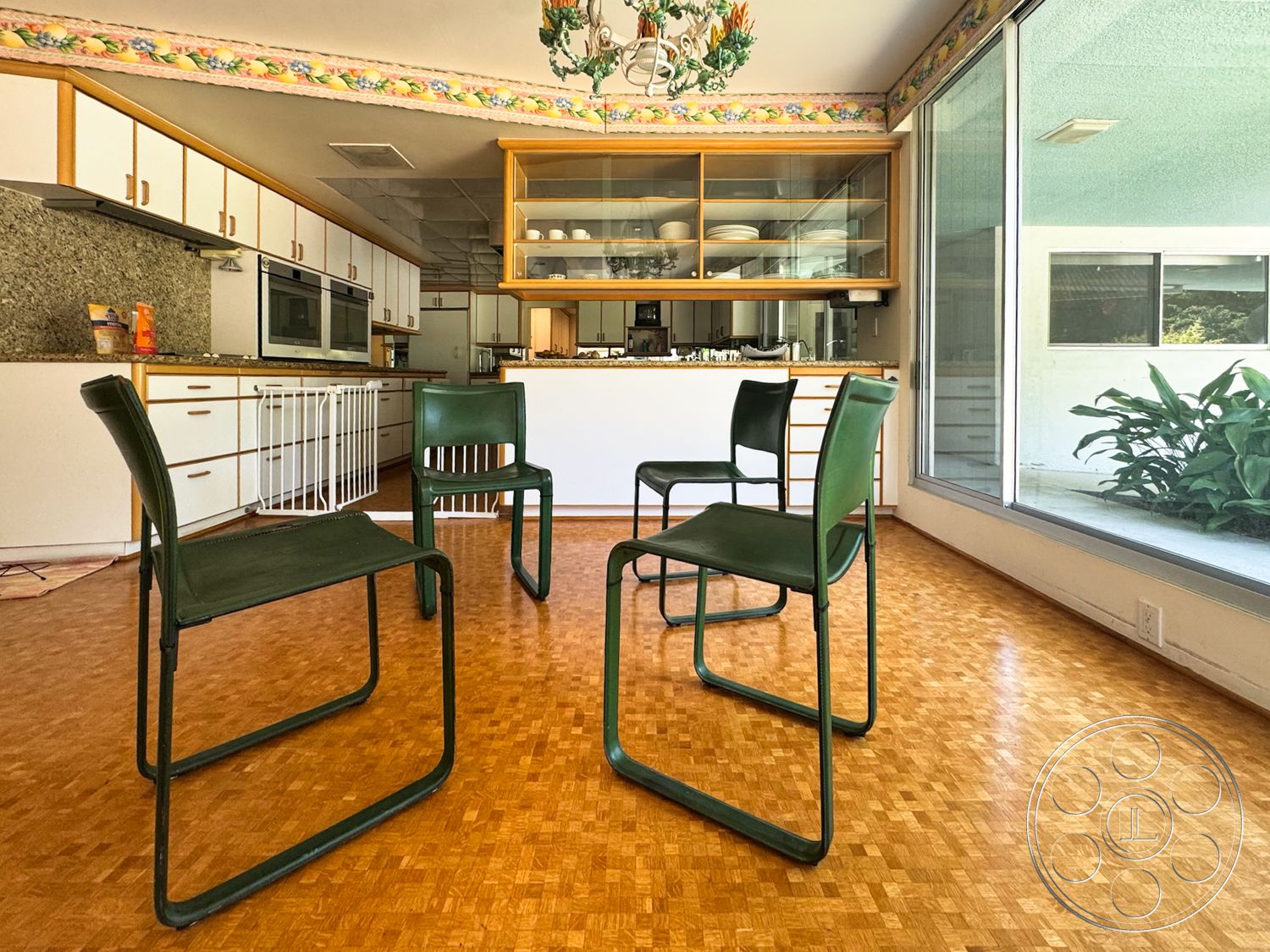 MCM 28 - glass windows, white cabinetry, decorative light fixture, metal dining chairs, modern kitchen design, granite kitchen countertops, wood laminate flooring, open shelving units, colorful wallpaper border