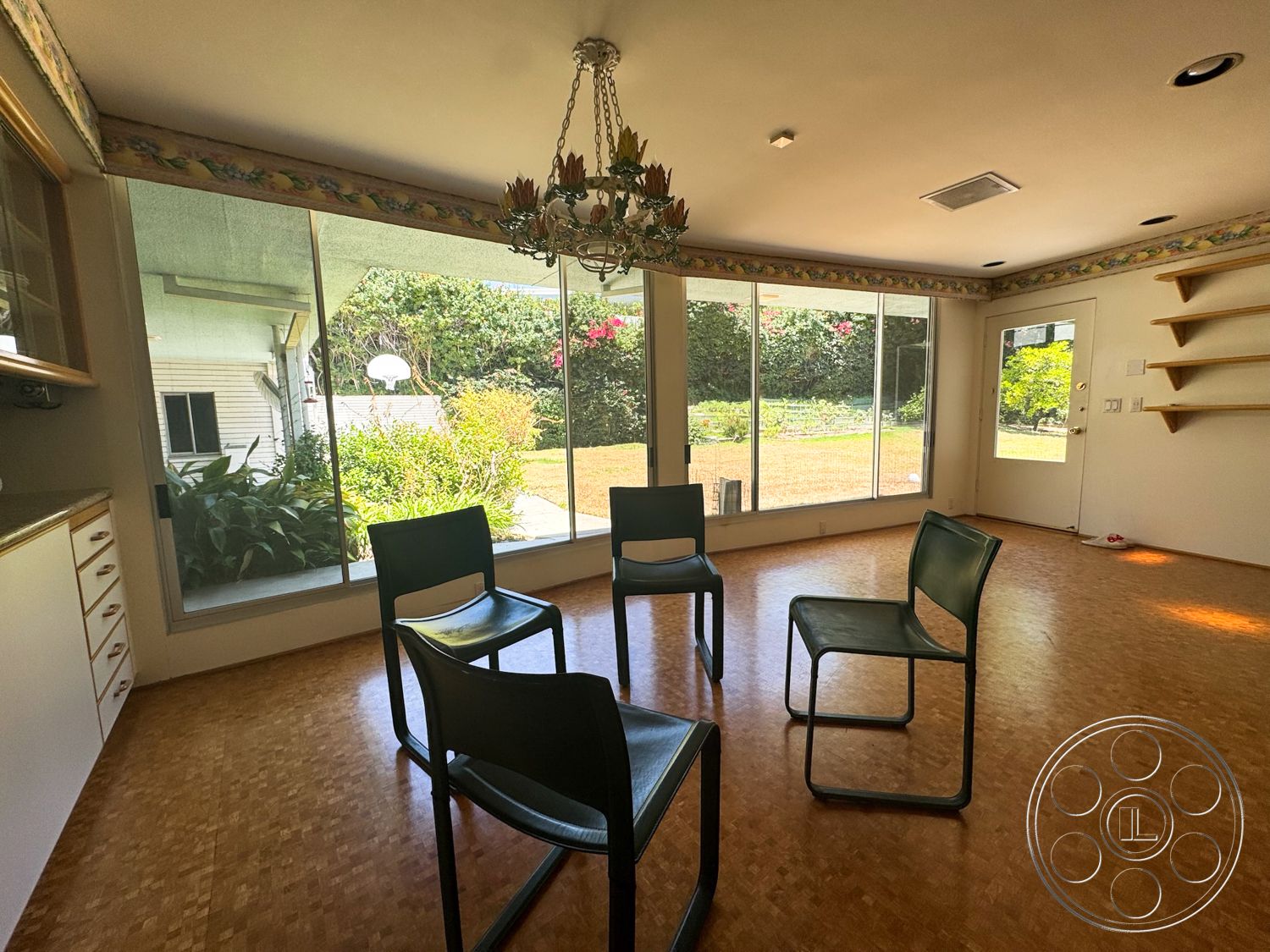 MCM 28 - natural light, minimalist design, open floor plan, garden view, decorative crown molding, large floor-to-ceiling windows, indoor seating area, chandelier light fixture, bamboo flooring, white painted walls, built-in shelving units, access door to exterior