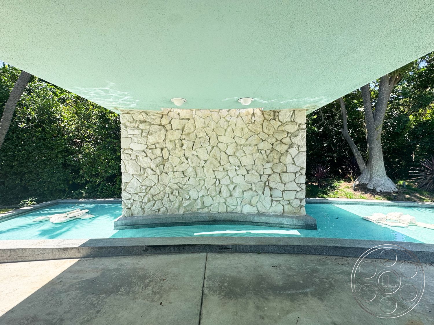 MCM 28 - exterior, palm trees, landscaped surroundings, green foliage, textured plaster ceiling, rectangular pool, outdoor lighting fixtures, stone feature wall, concrete patio flooring